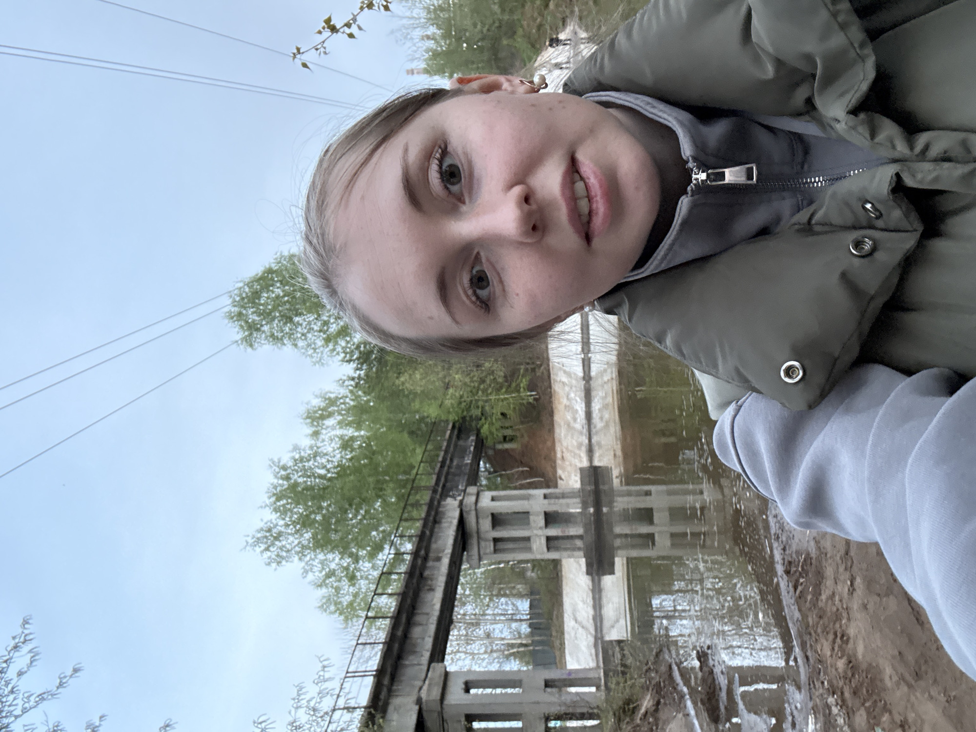 Woman photographs herself at Russian-marked concrete bridge structure