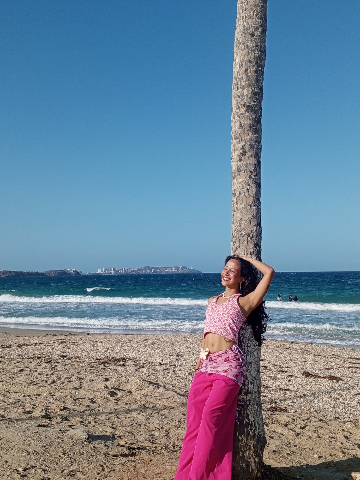 Woman poses for beach portraits in Porlamar, Venezuela