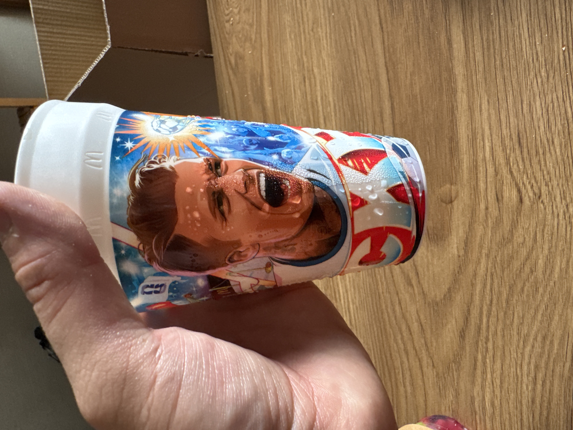 Condensation-covered cup with face print held in Tbilisi