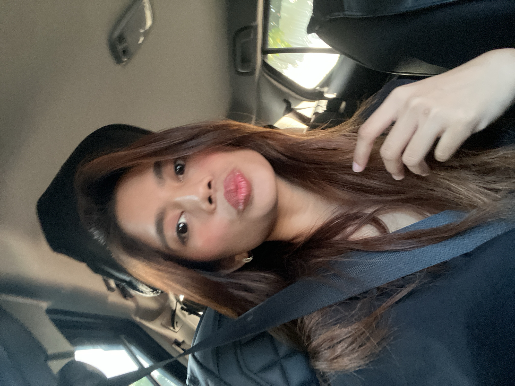 Young woman takes selfies in car, Davao City