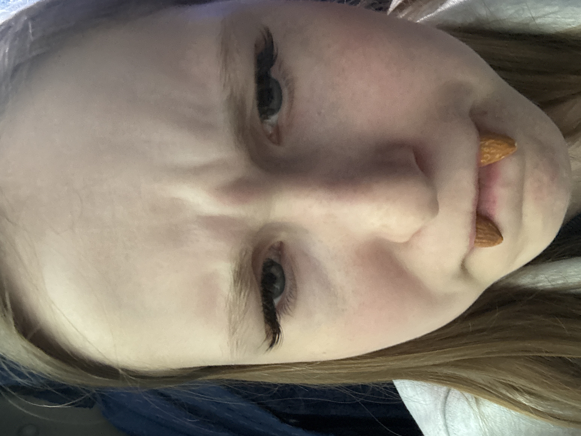 Person poses with almonds as fangs in Russia portrait