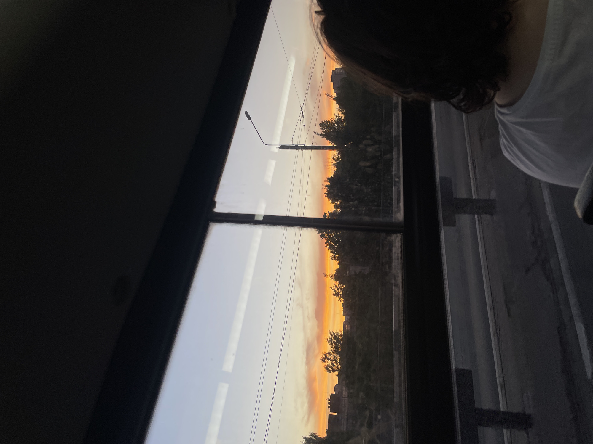 Vibrant sunset observed over Saint Petersburg skyline from vehicle
