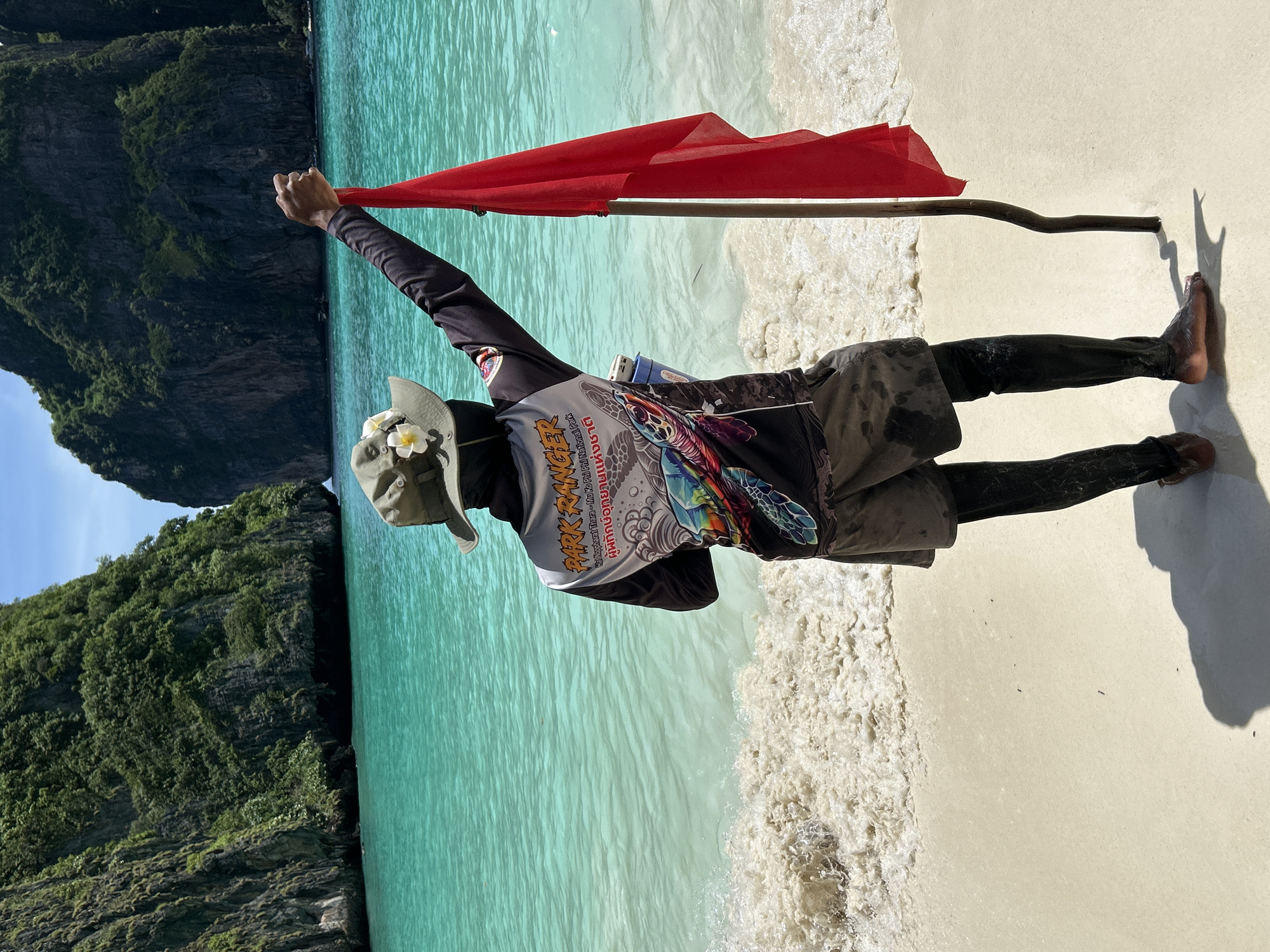 Park ranger manages tourist crowd at Ao Nang limestone beach