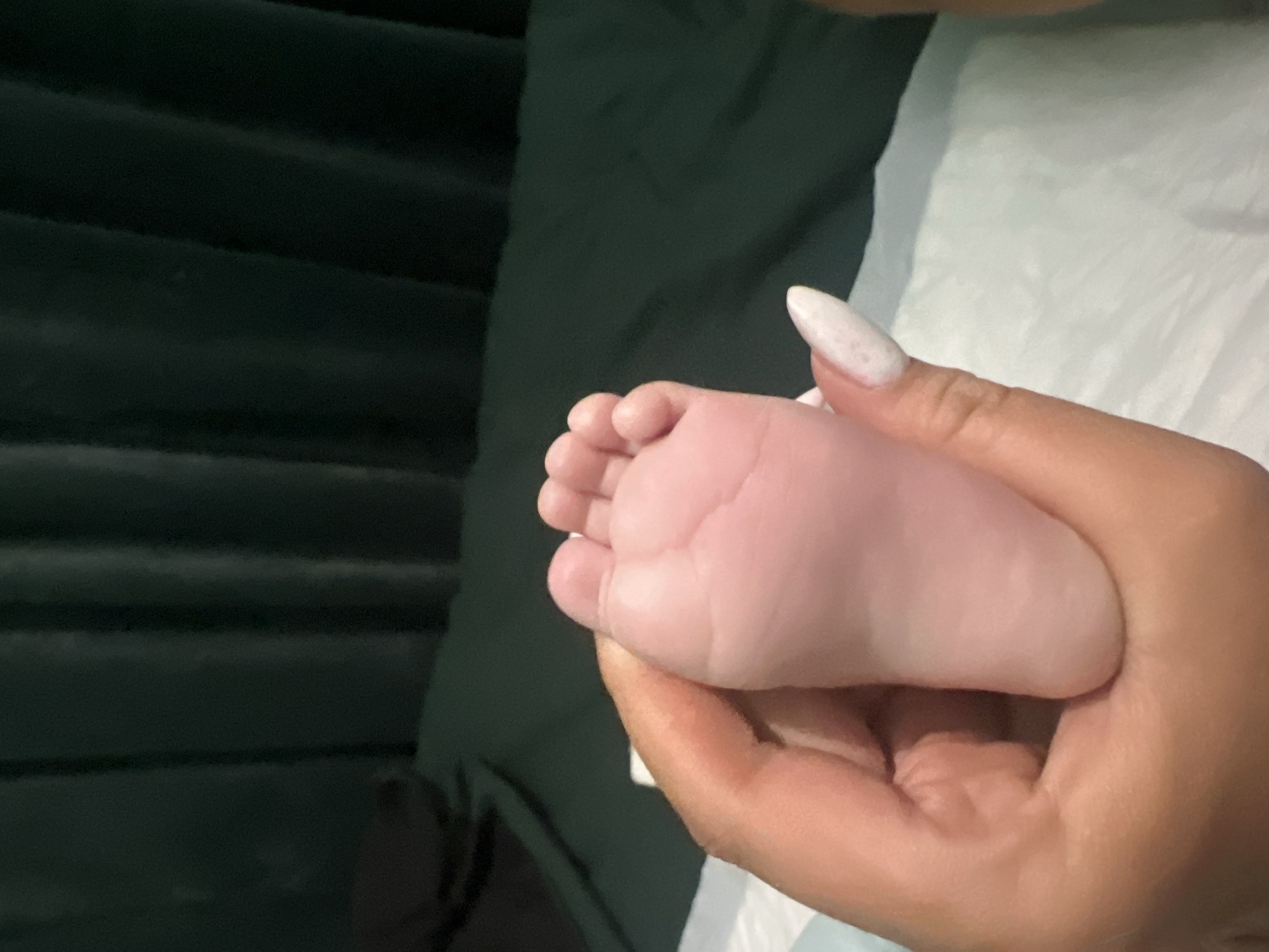 Adult holds baby's foot in Plovdiv, Bulgaria