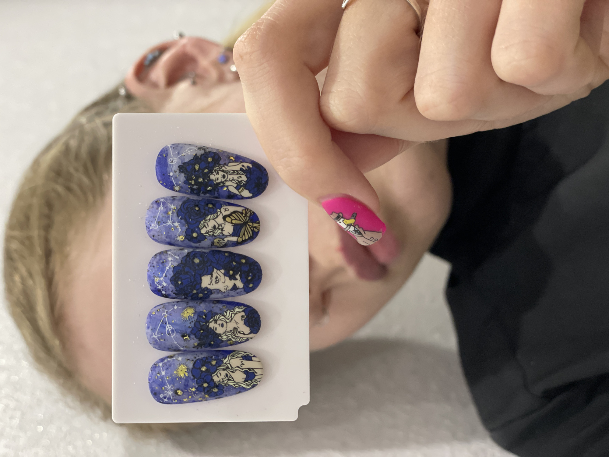 Person displays decorative nail art designs in Izhevsk