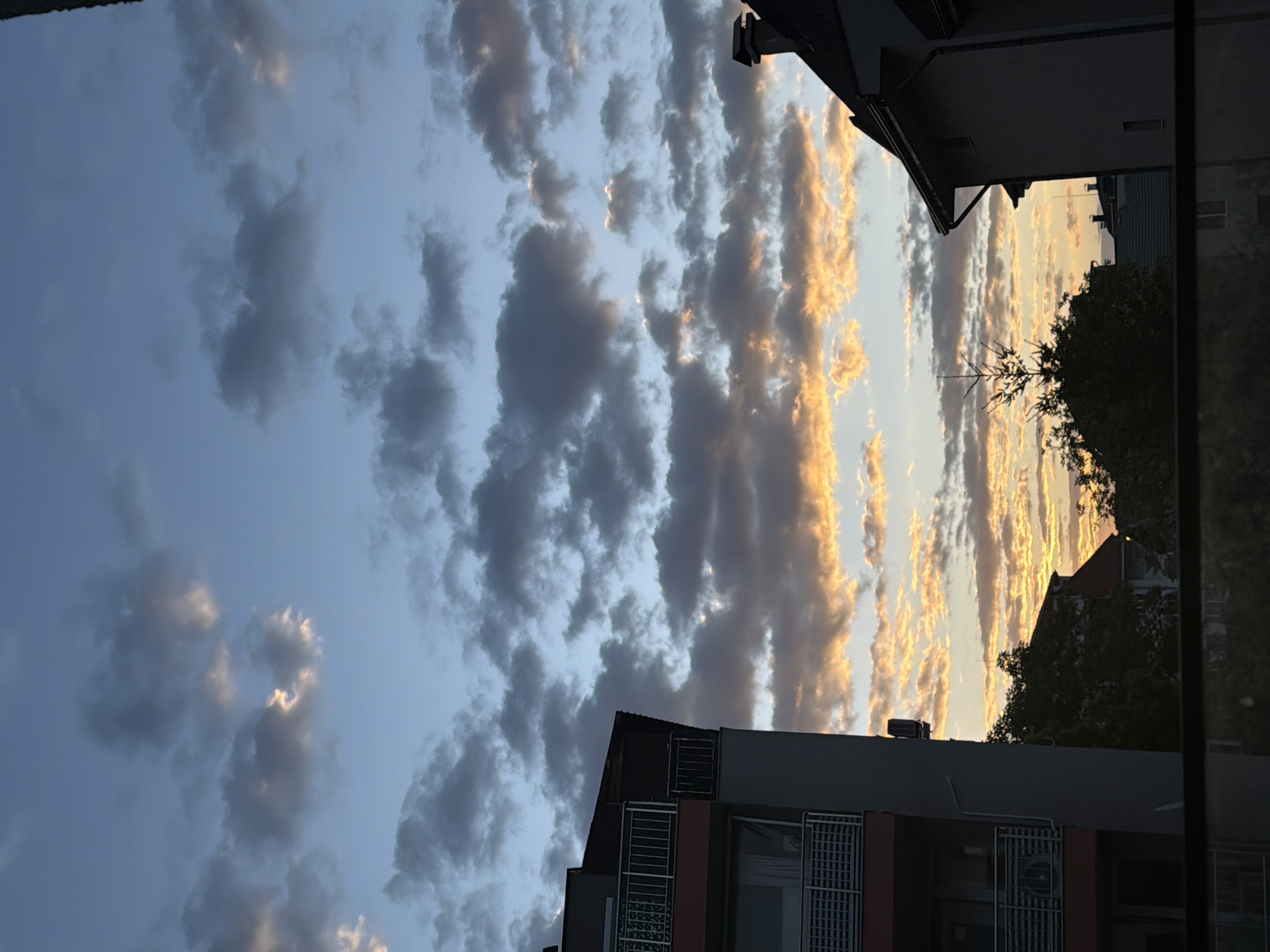 Golden sunset illuminates cloudy skies over Sofia, Bulgaria