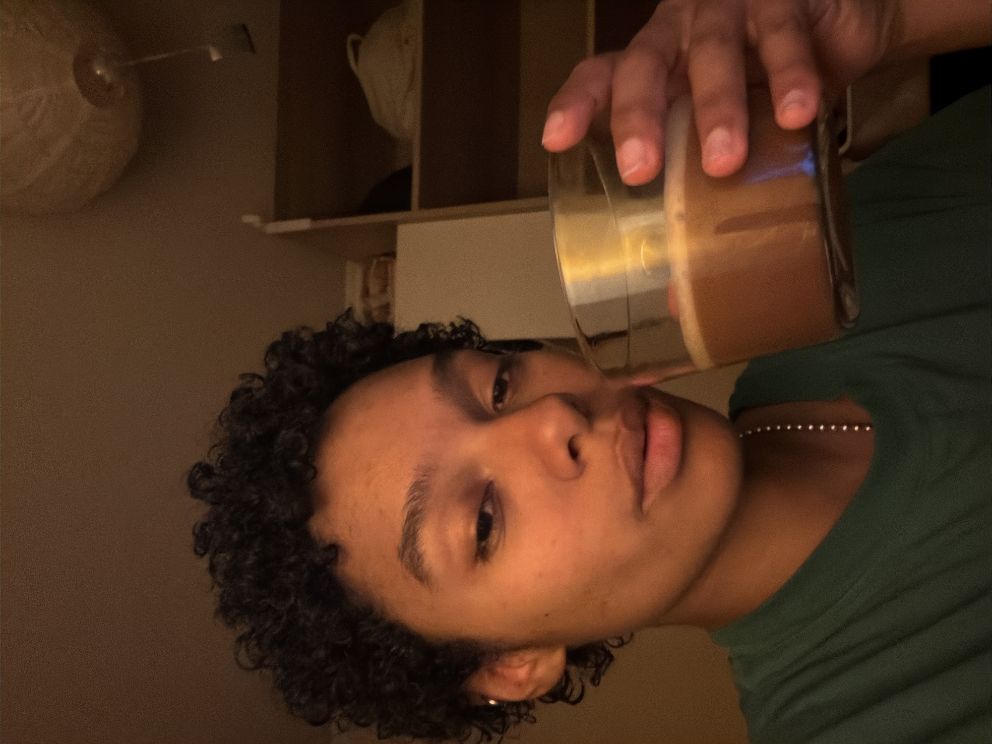 Person enjoys brown beverage in Champs-sur-Marne evening