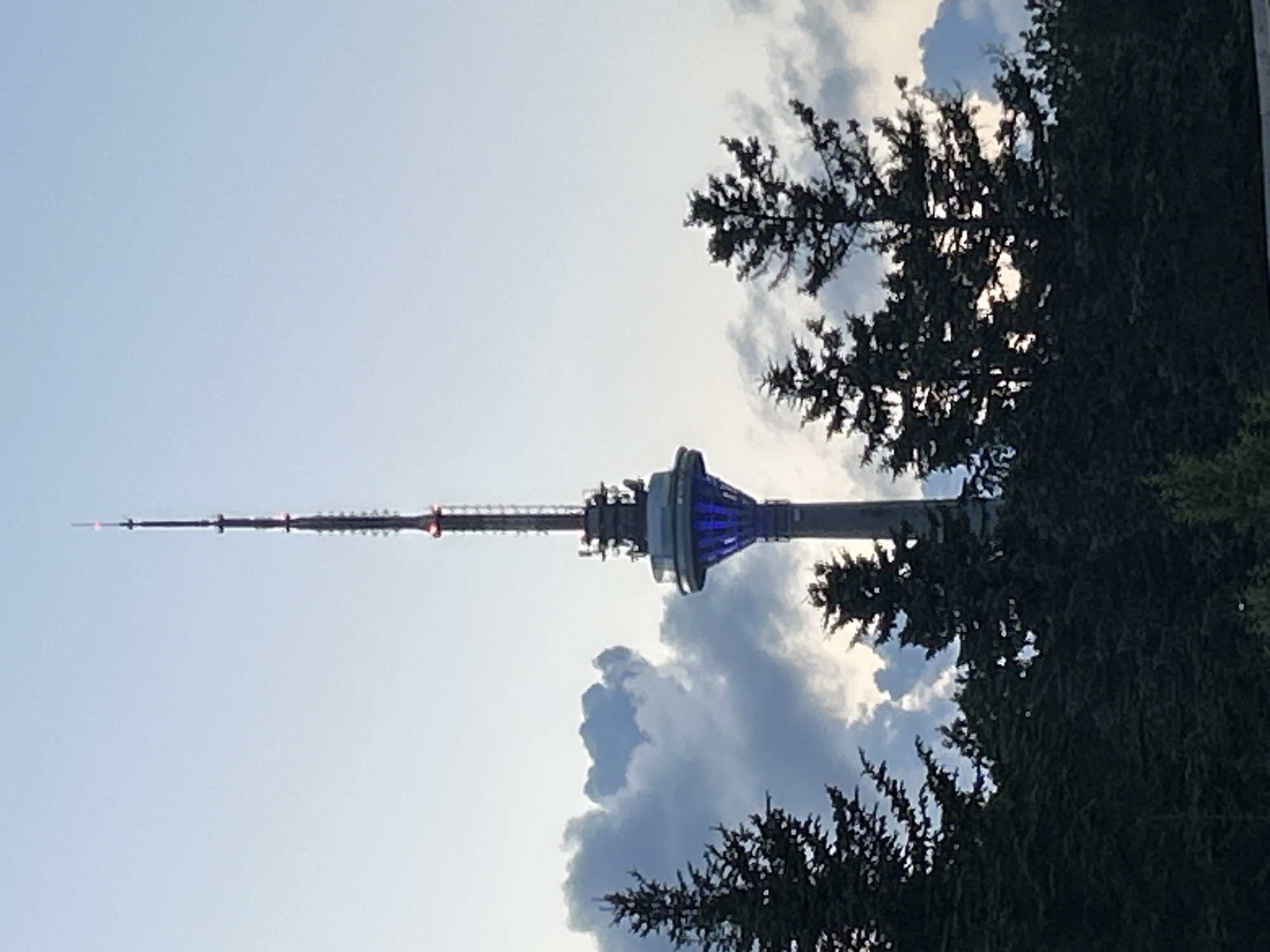 Tallinn TV Tower glowing at dusk against a cloudy sky