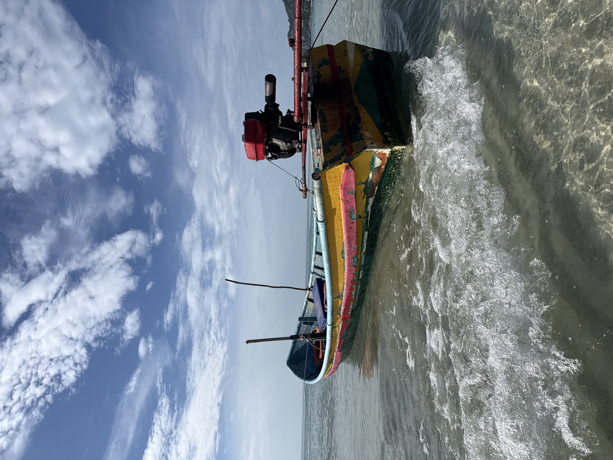 Colorful fishing boat resting in shallow Ko Samui waters