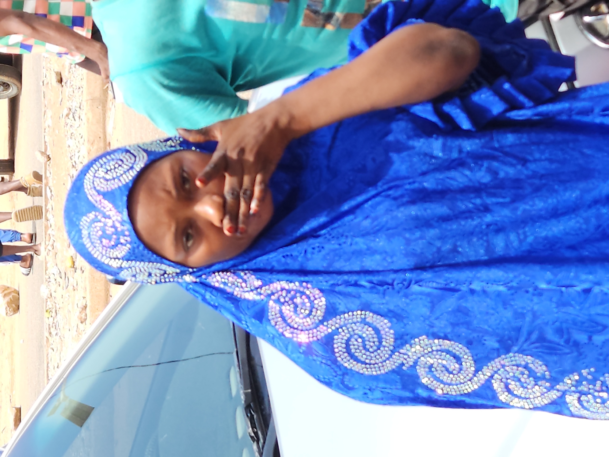 Daily street life documented outside Nigerian electronics store