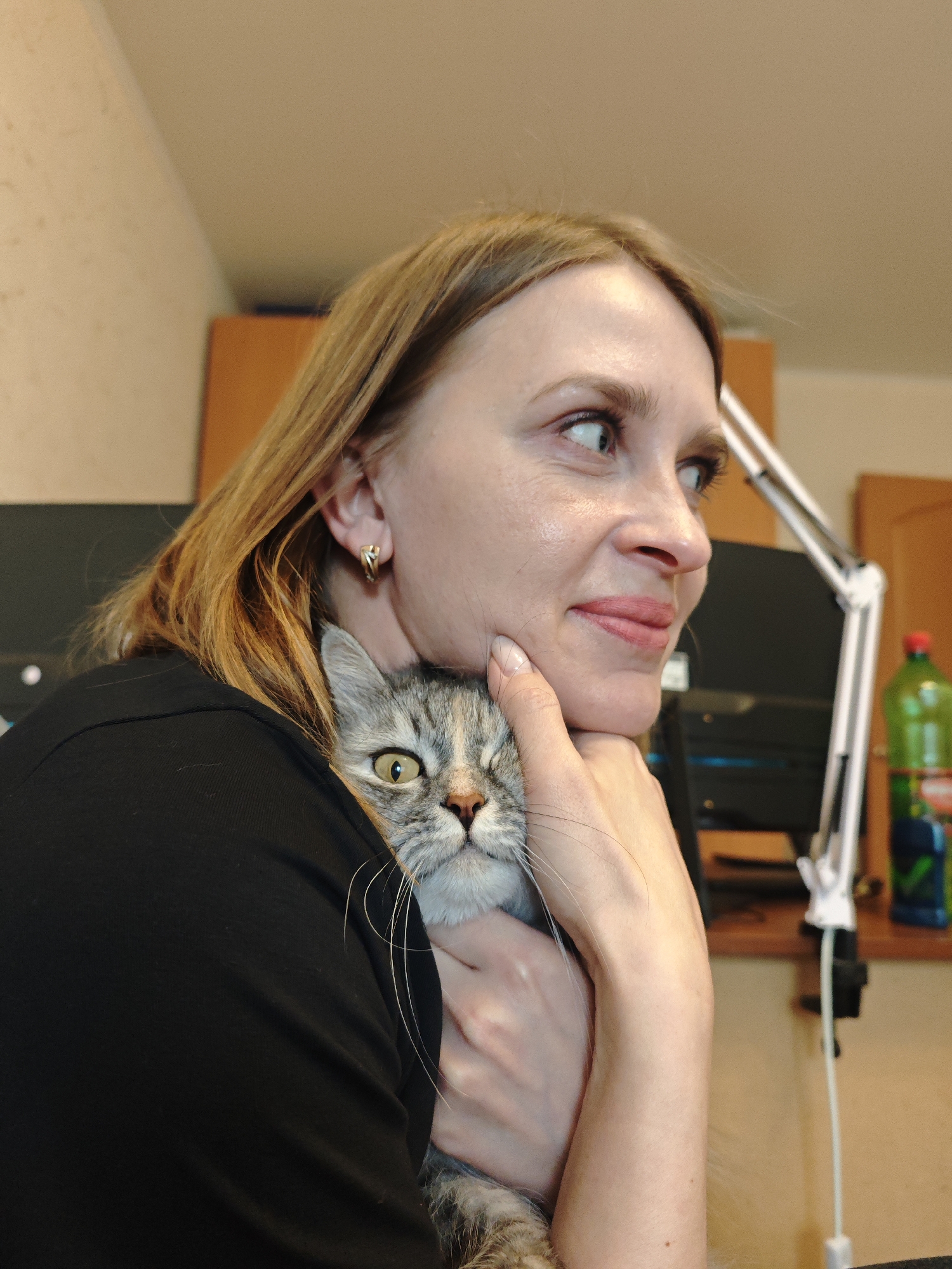 Woman poses with tabby cat in Samara, Russia