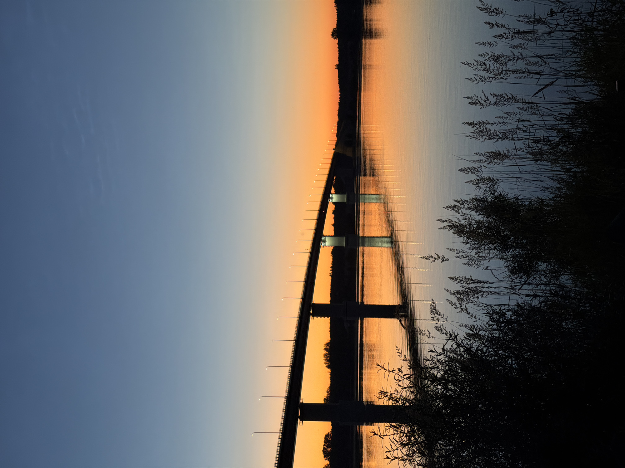 Sunset over a river bridge in Tarasovo, Russia