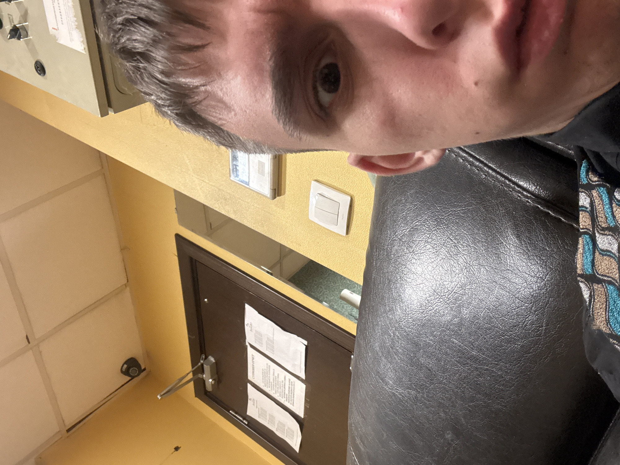 Man Takes Selfie in Yellow-Walled Indoor Space in Sofia