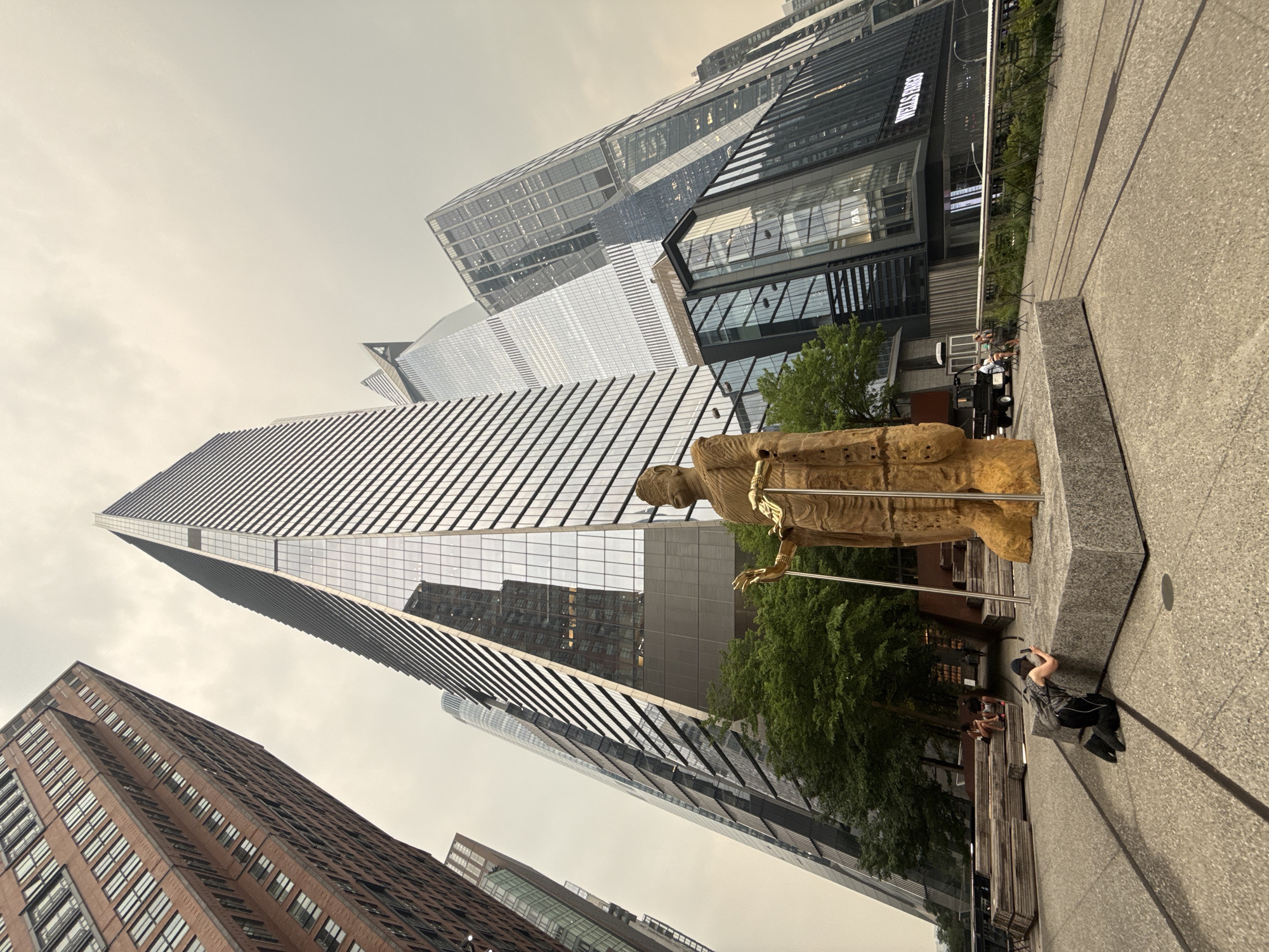 Golden statue and glass towers at Hudson Yards