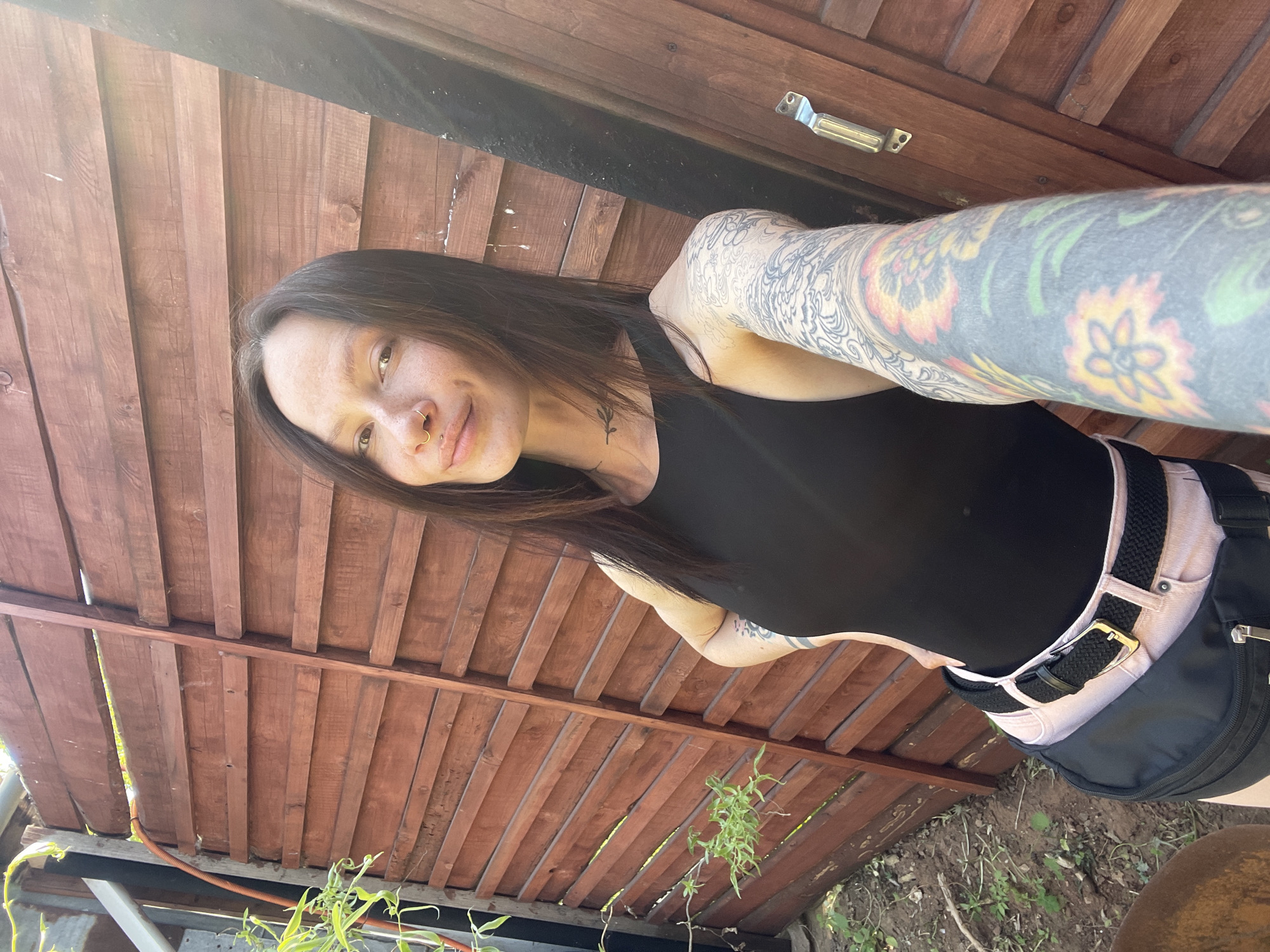 Woman photographed near wooden structure in Chemoshur, Russia