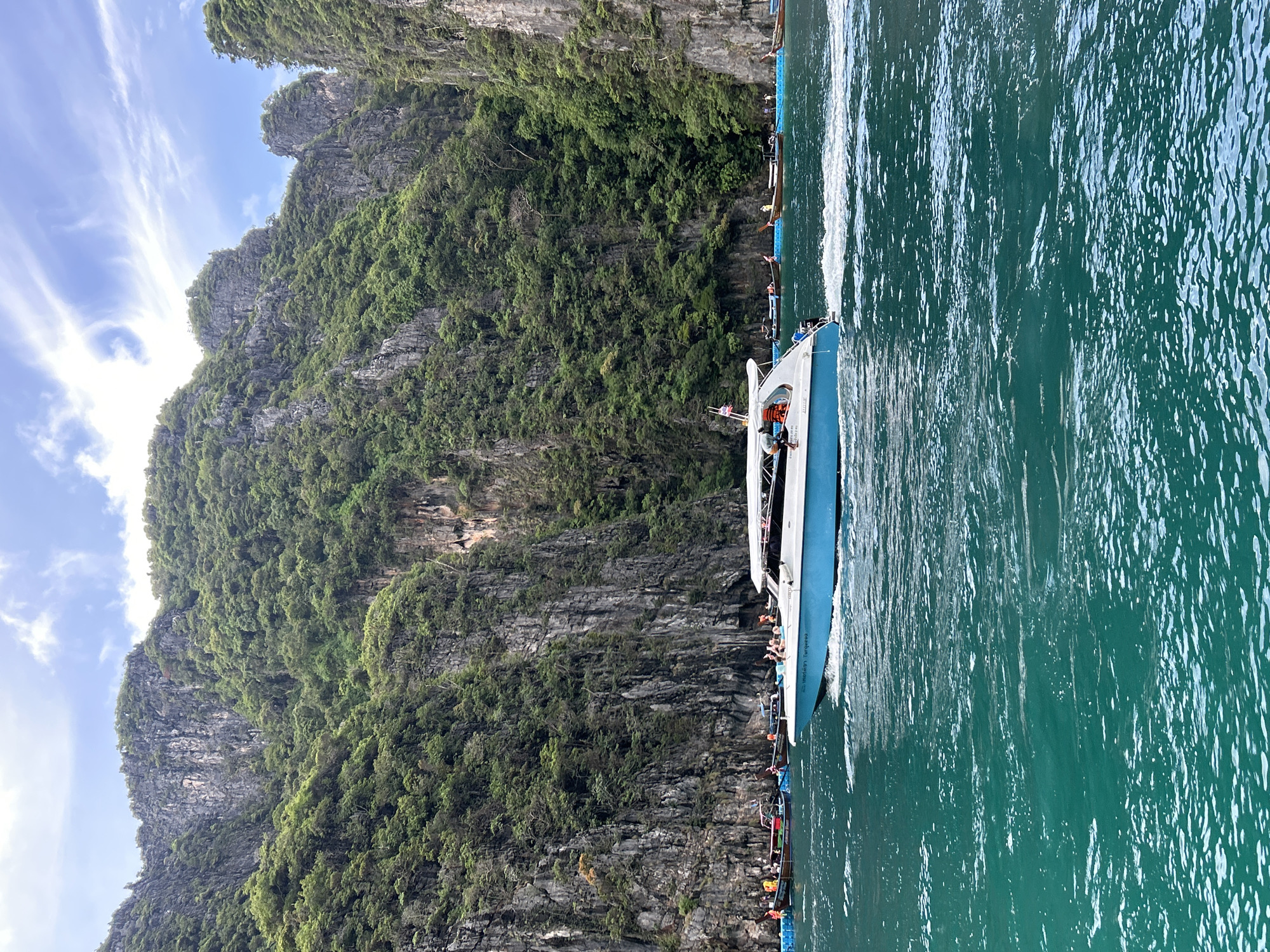 Speedboats and longtails navigate Ao Nang's limestone karst waters