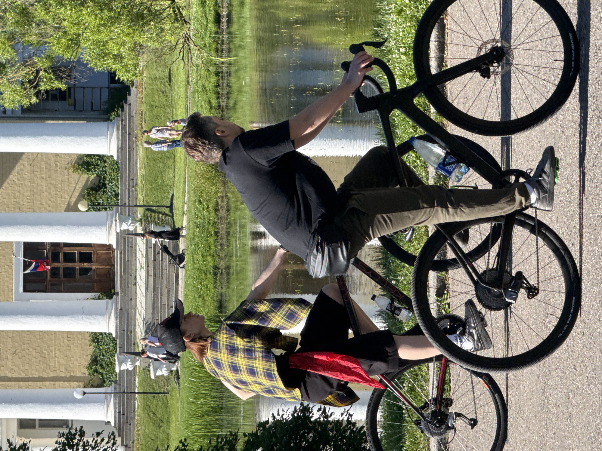 Sunny afternoon cycling and strolling beside a Moscow park pond