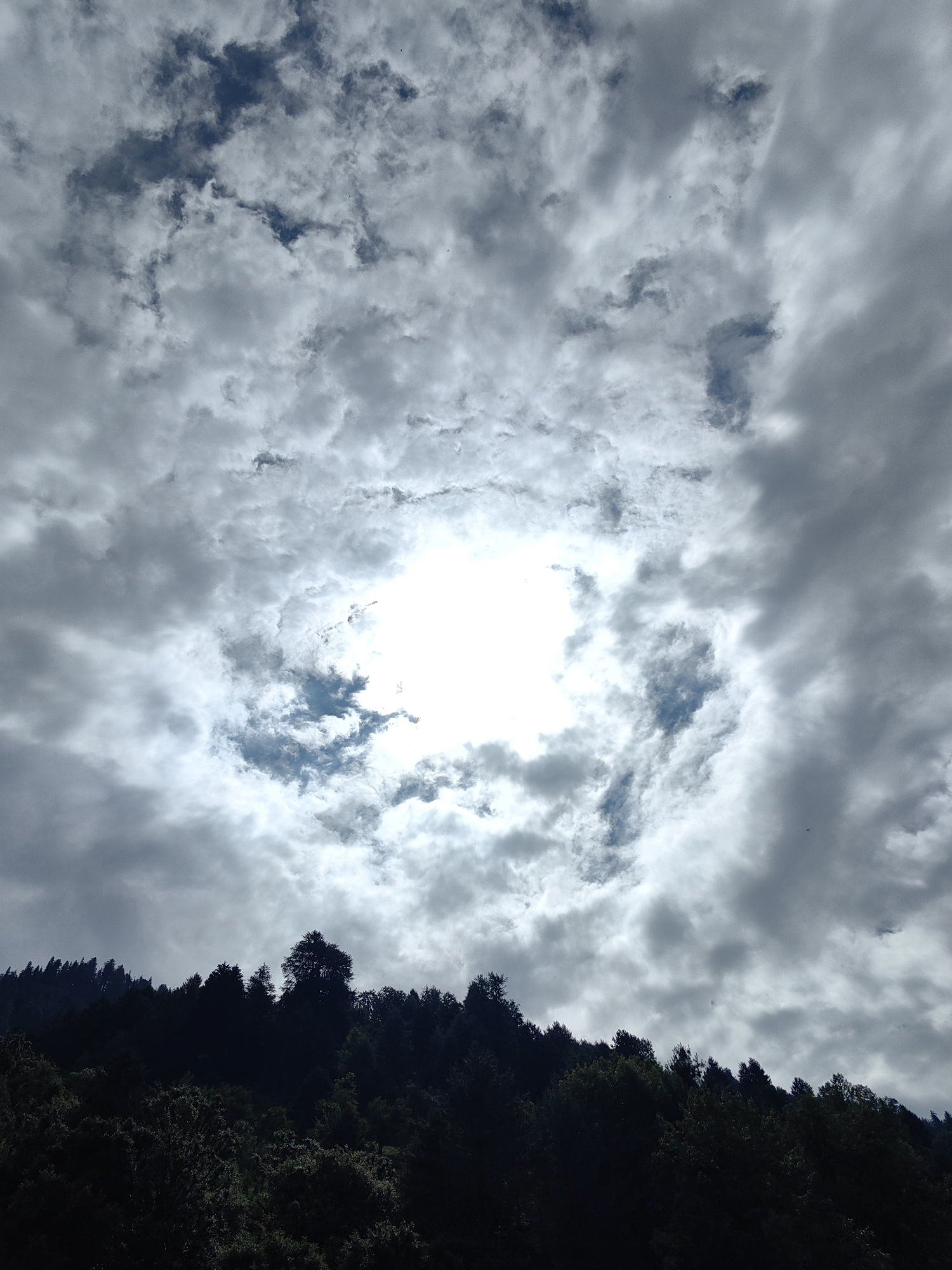 Vashisht valley and peaks under moody, shifting skies