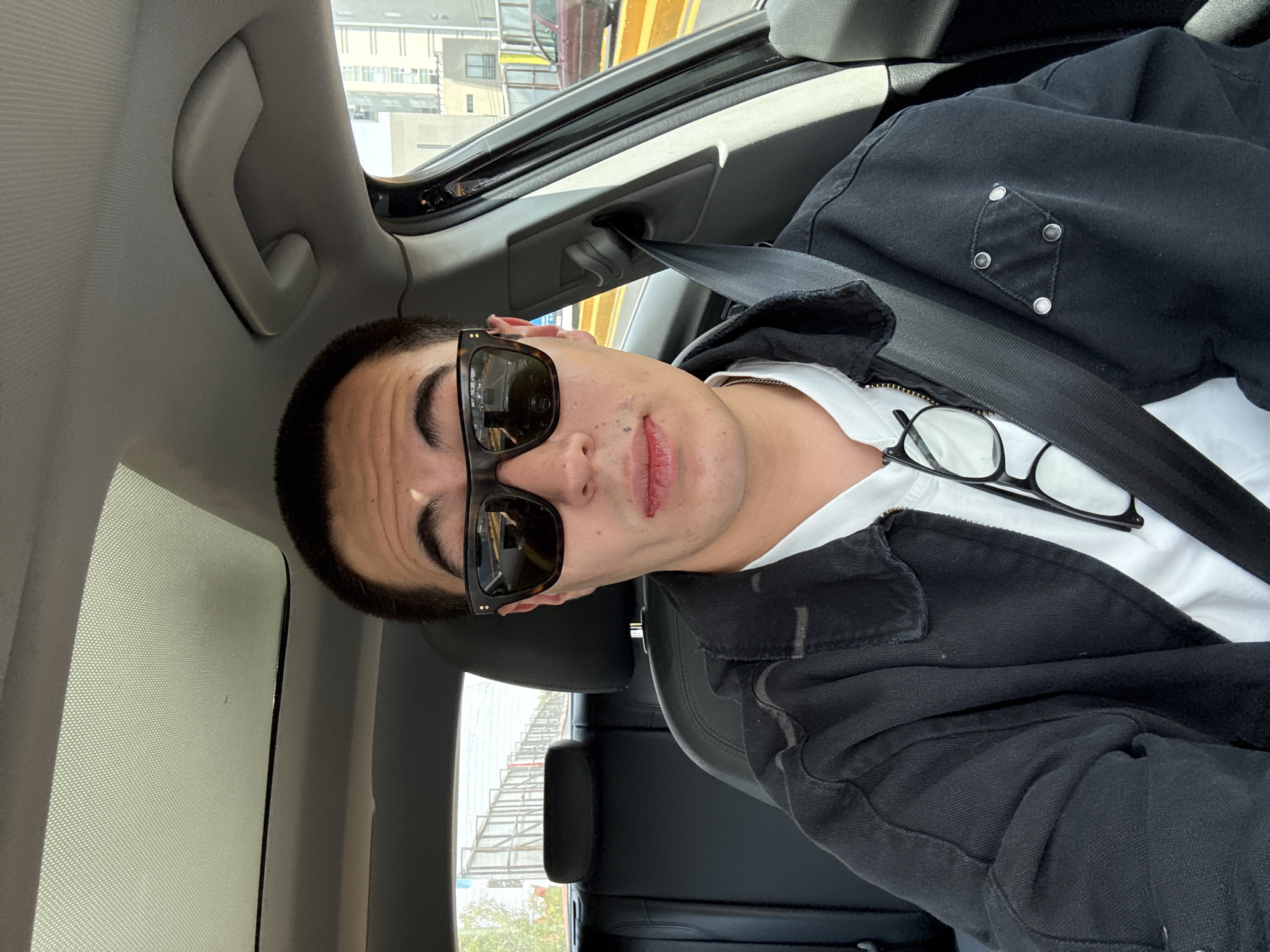 Young man photographed in car passenger seat in Puebla