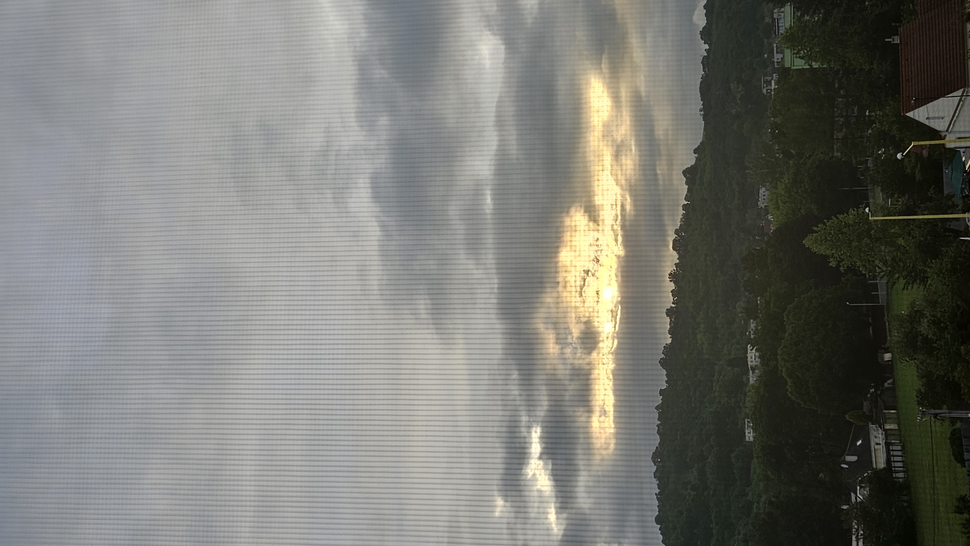 Witness captures sunset landscape view through window in Prešov