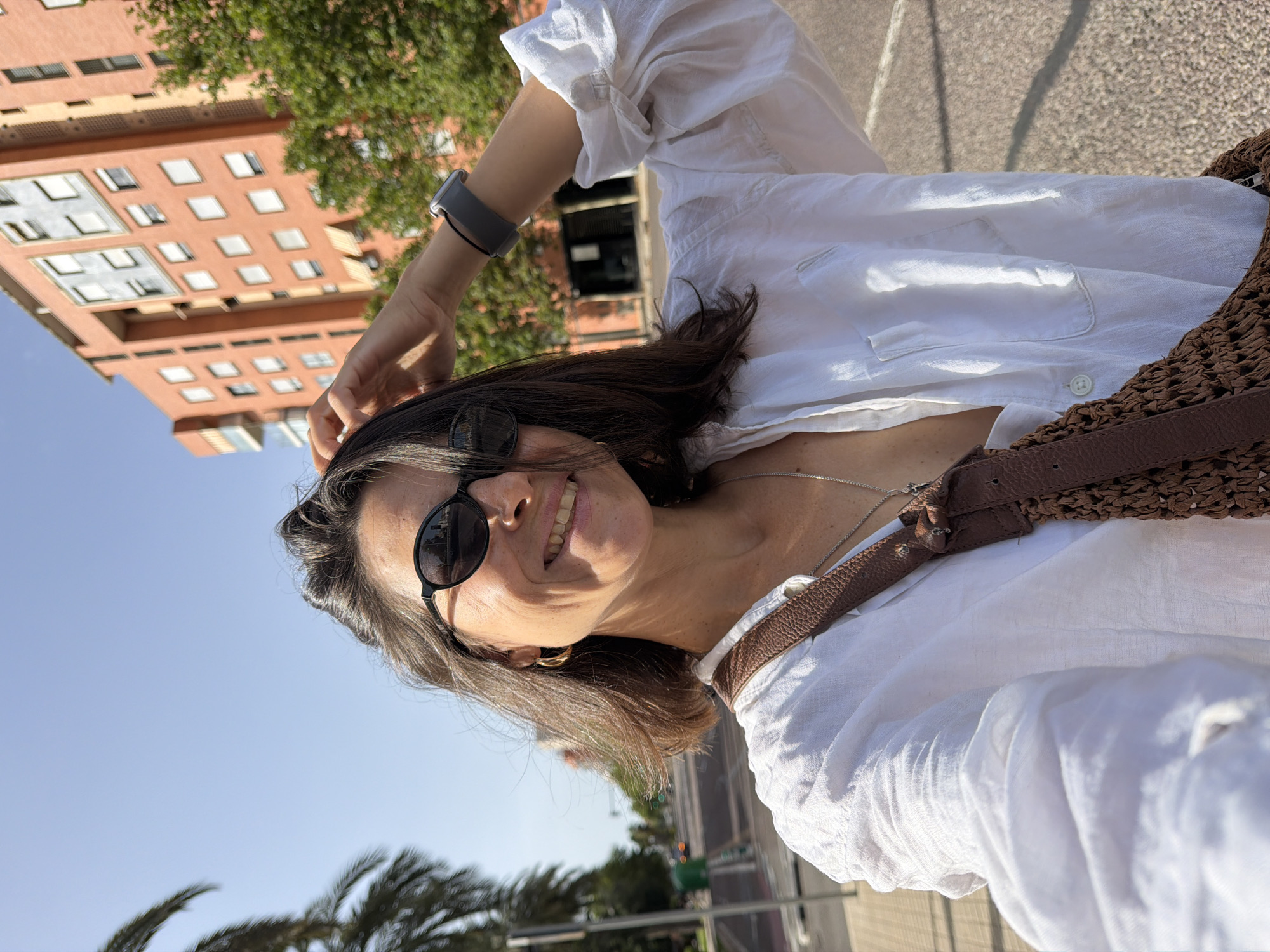 Sunny day selfies, neon art, and a palm-lined city street.