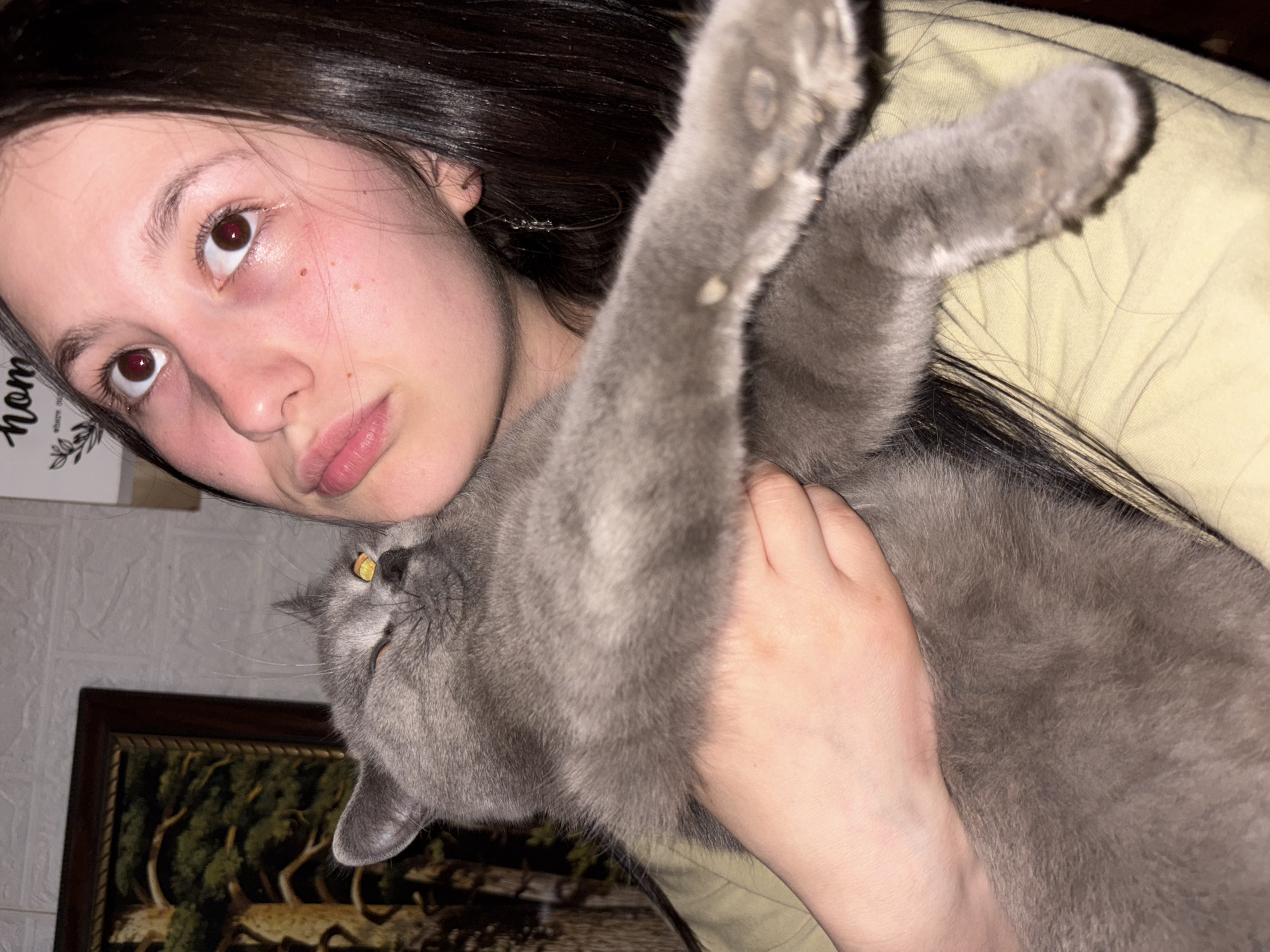 Woman and gray cat photographed together in Russian home