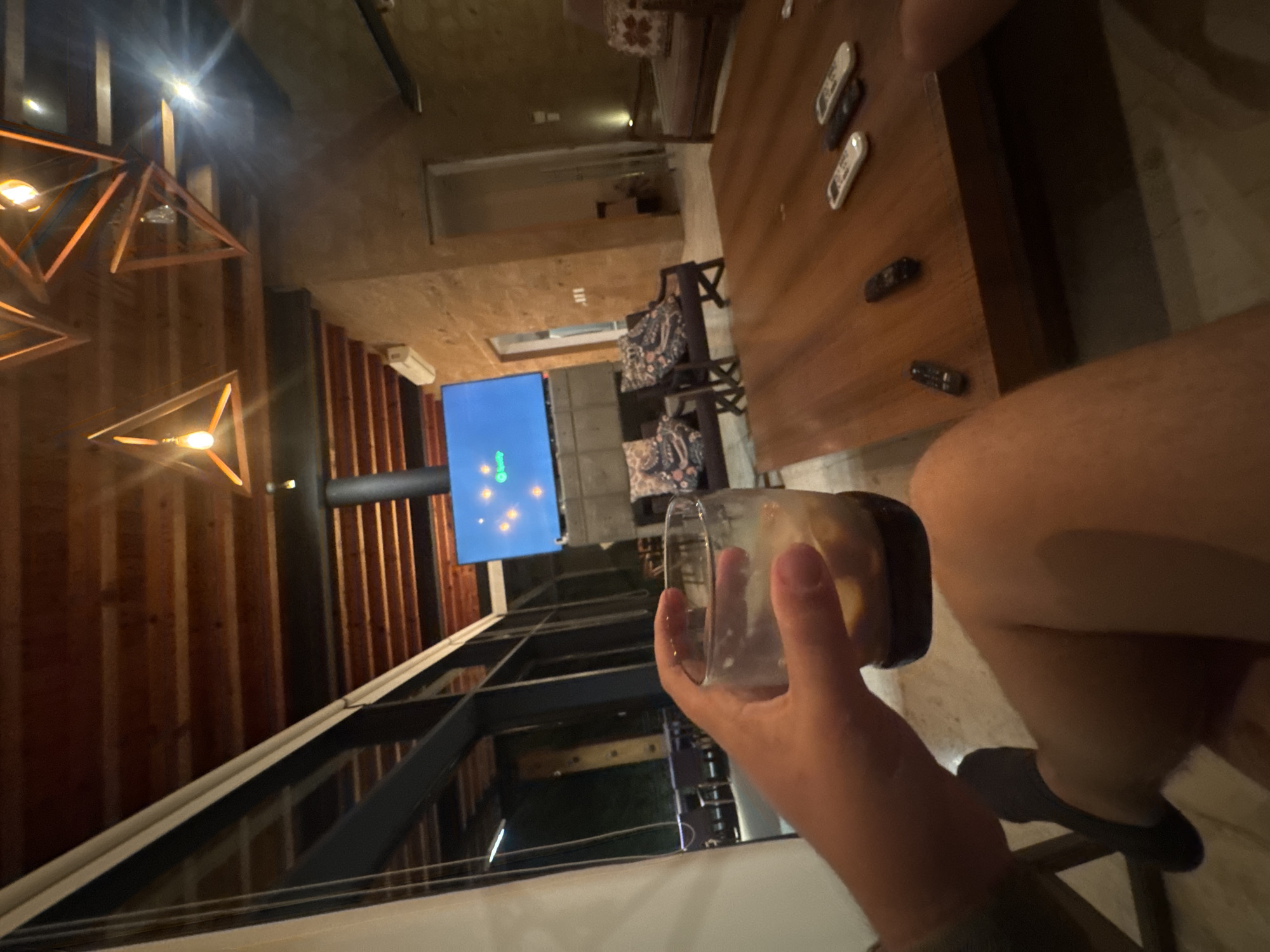 Person holds empty glass in Valle de Bravo interior