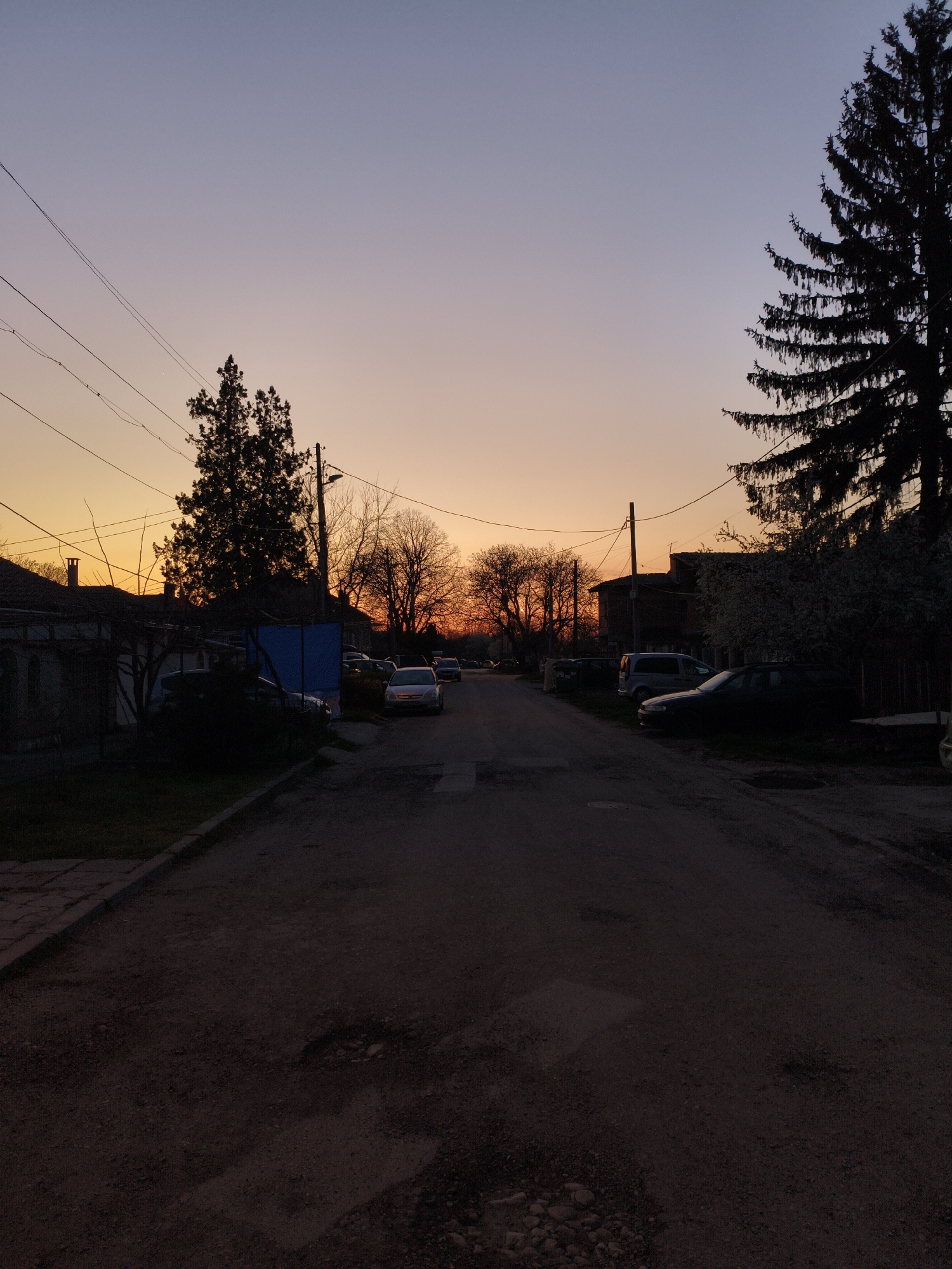 Sunset captured on unpaved residential street in Dobrich, Bulgaria