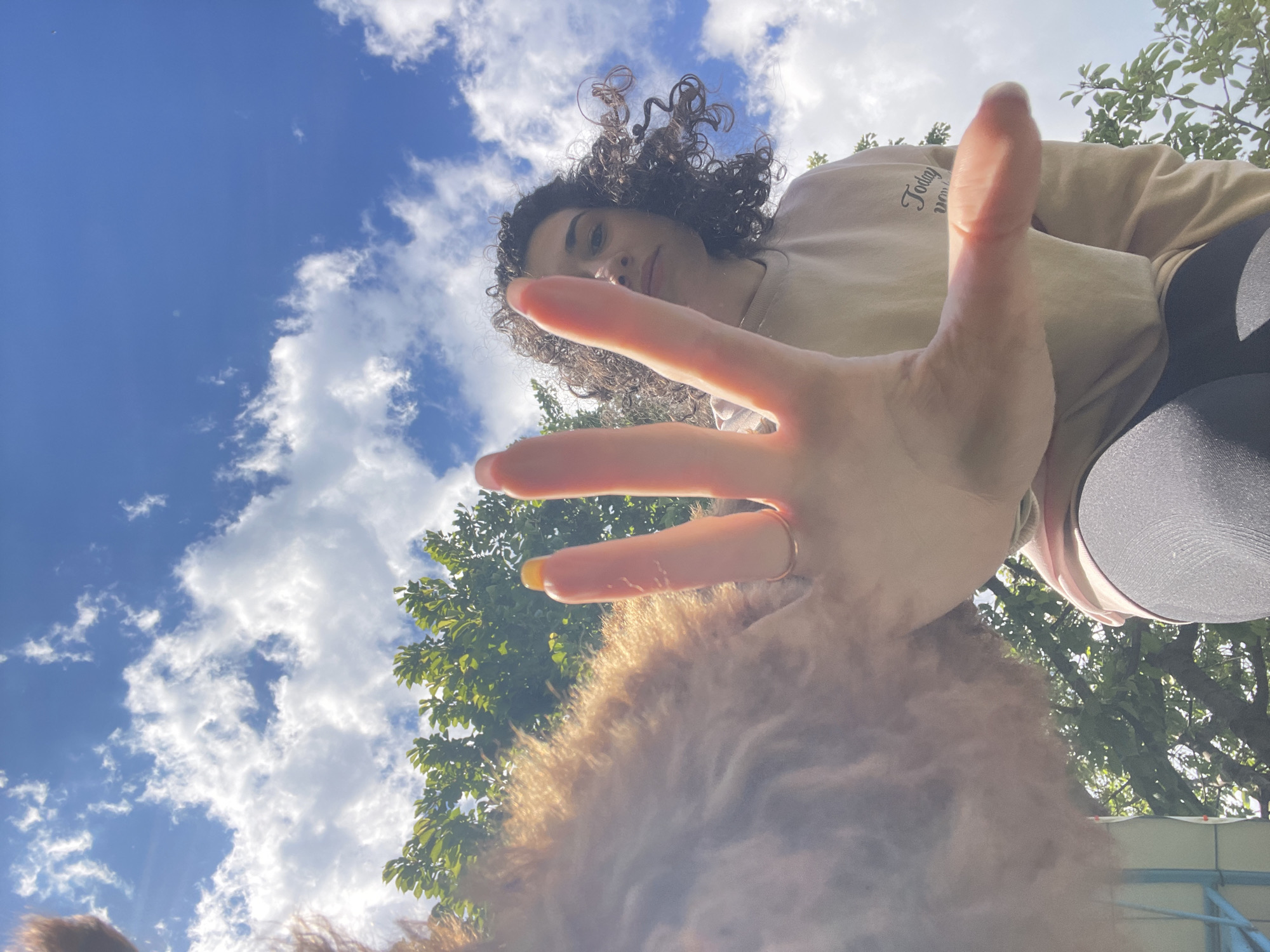 Woman plays with poodle in Sofia park