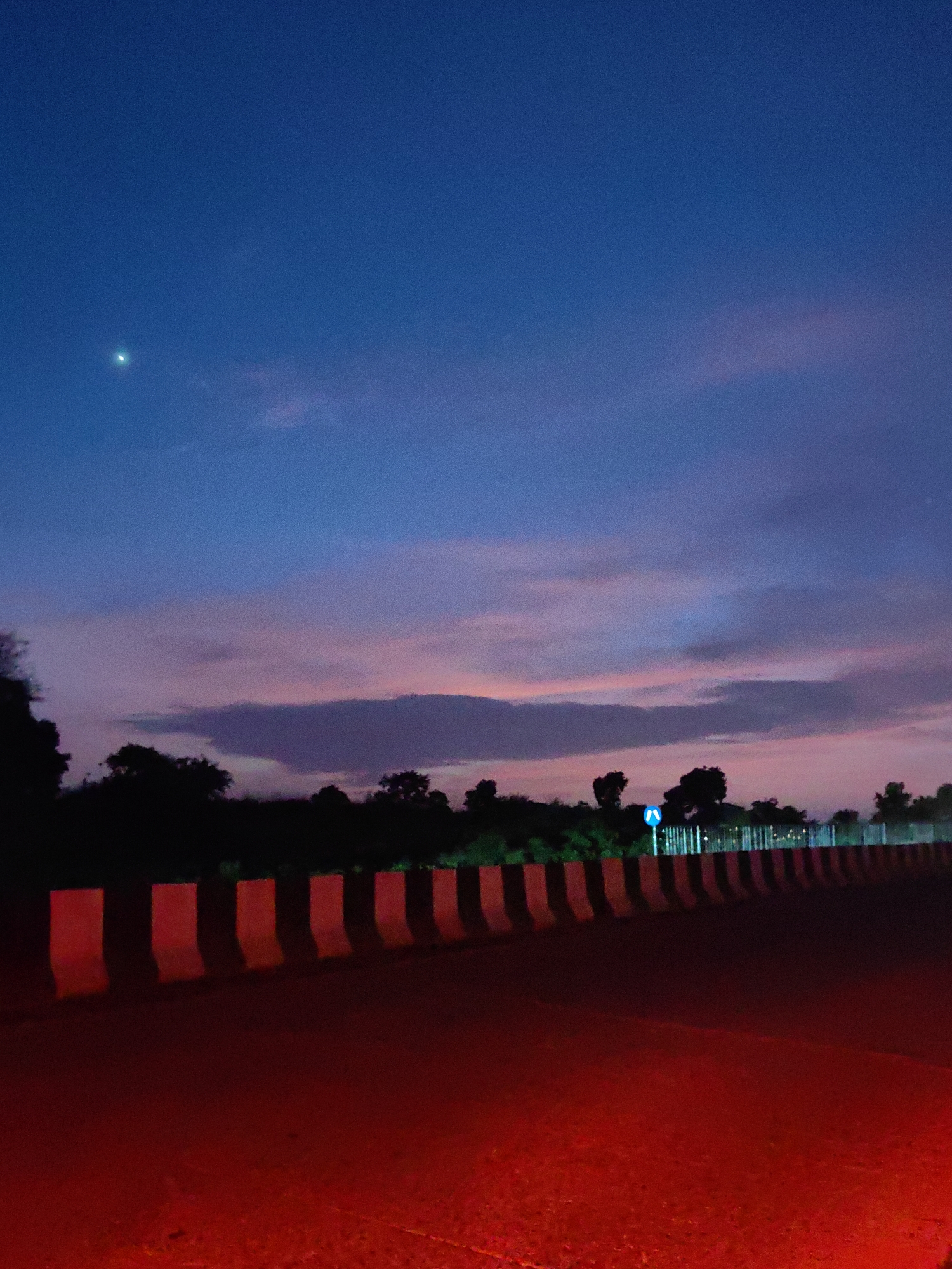 Sunset fades to night on a road in Umale, India