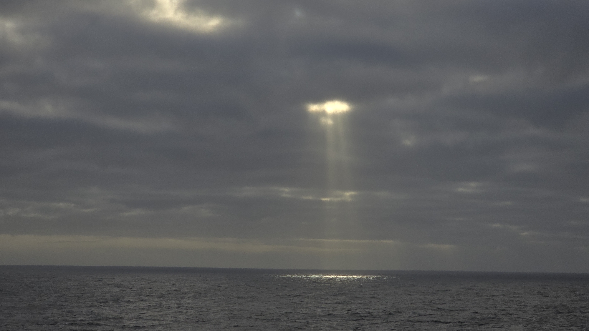 Sunbeams pierce clouds over Norwegian waters near Randaberg