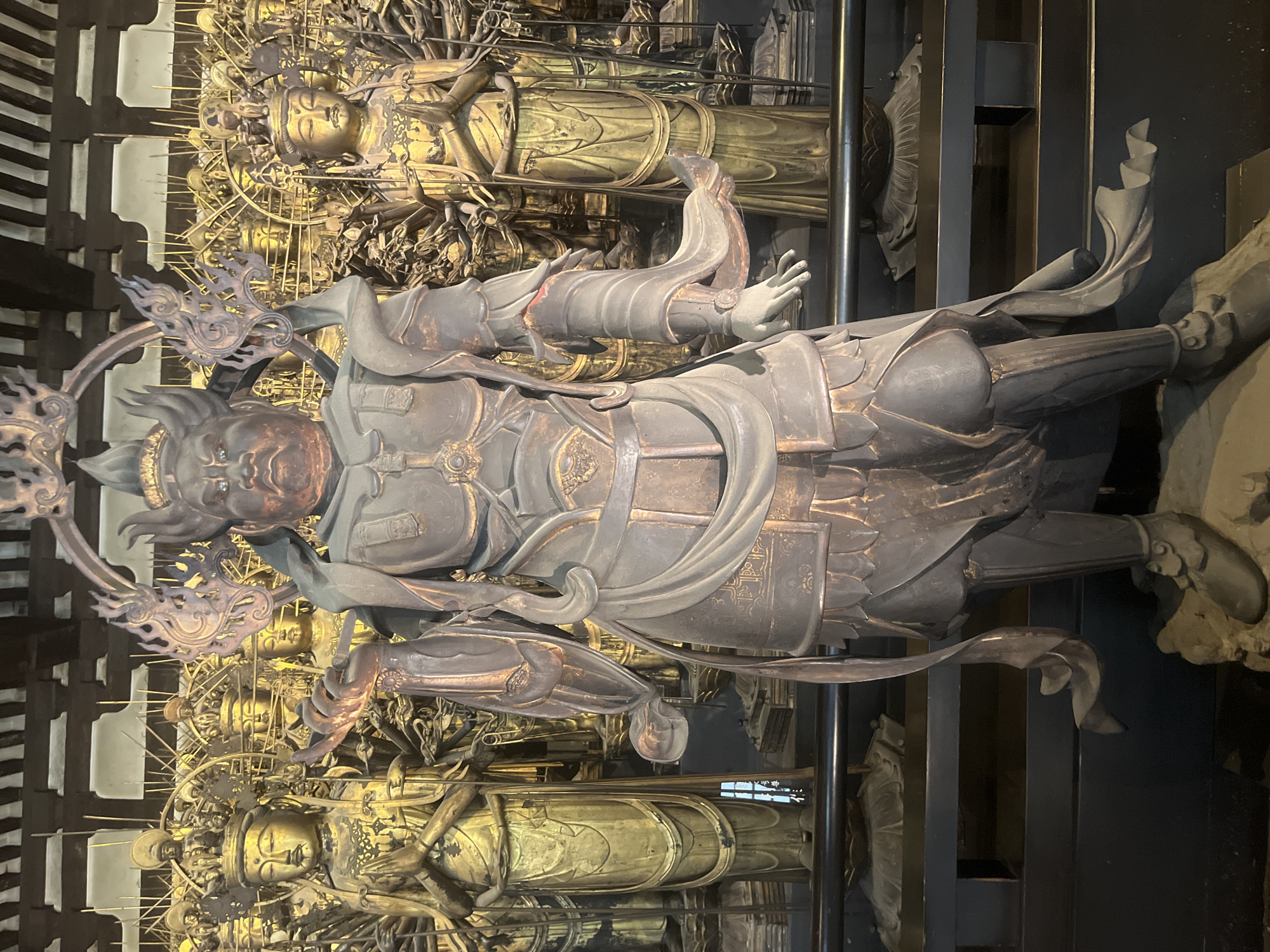 Tourists explore famous Buddhist temple statues in Kyoto