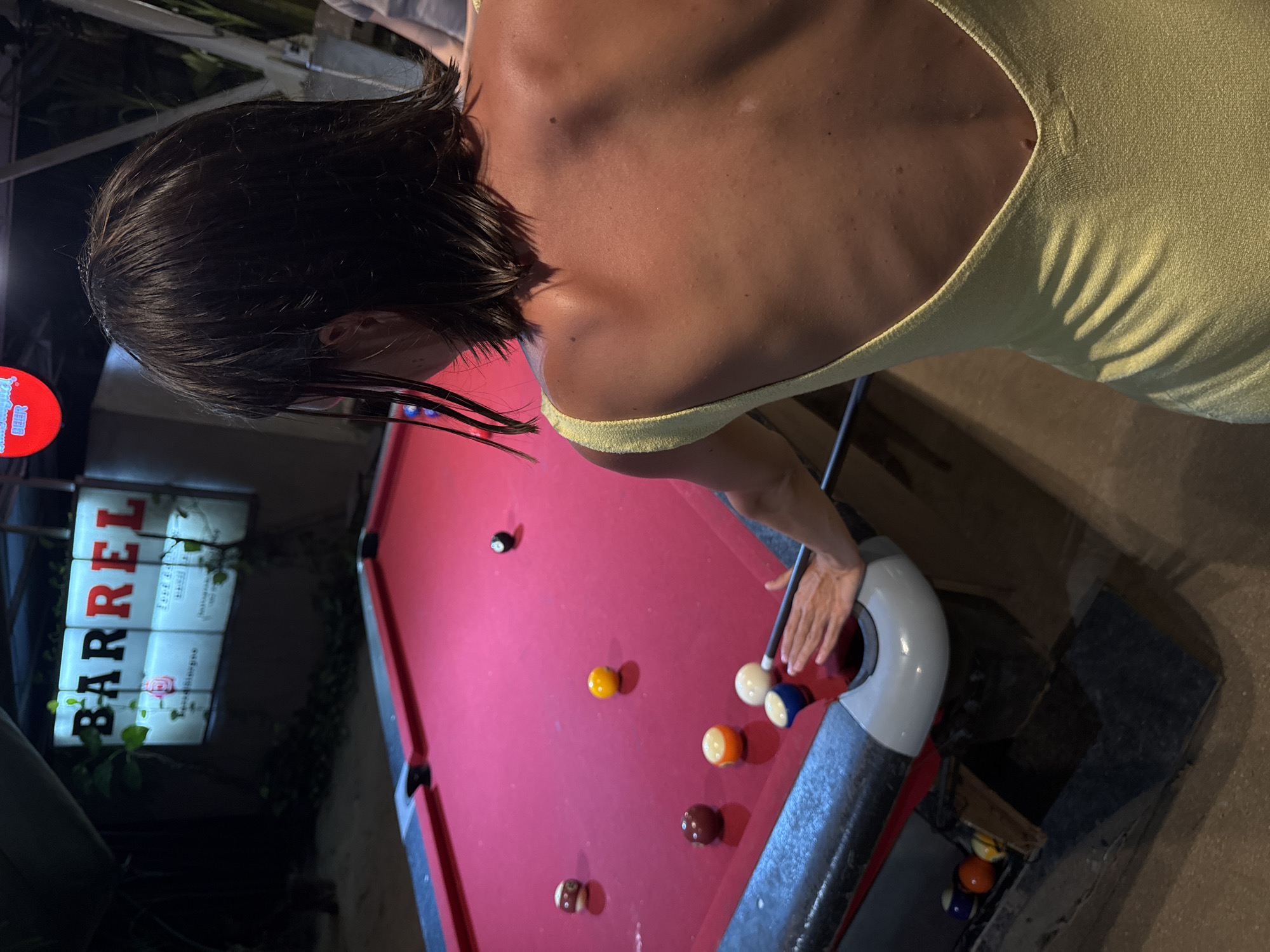 Woman plays outdoor pool in General Luna, Philippines