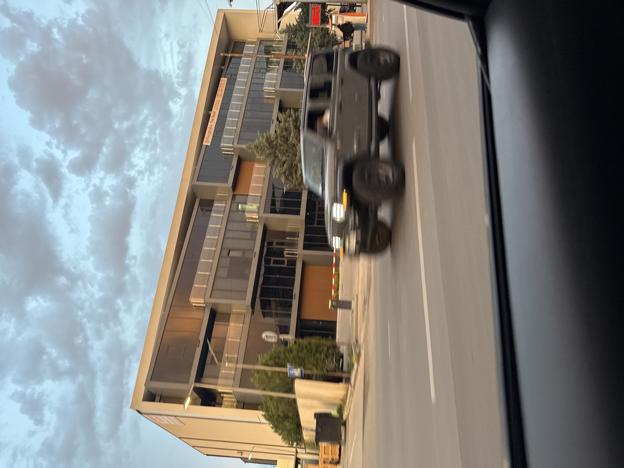 Evening drive through Tbilisi past construction, traffic, and wet streets