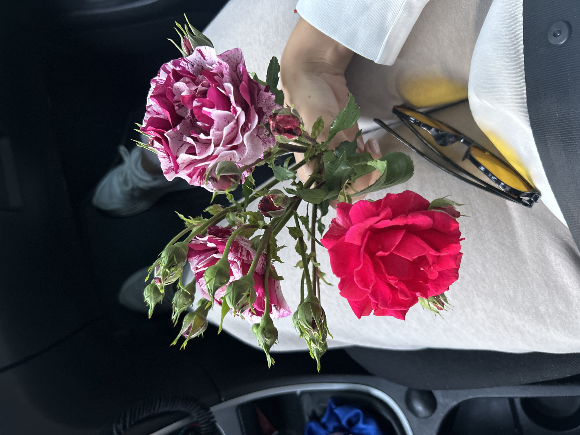 Person spotted with roses, food, coffee in urban setting