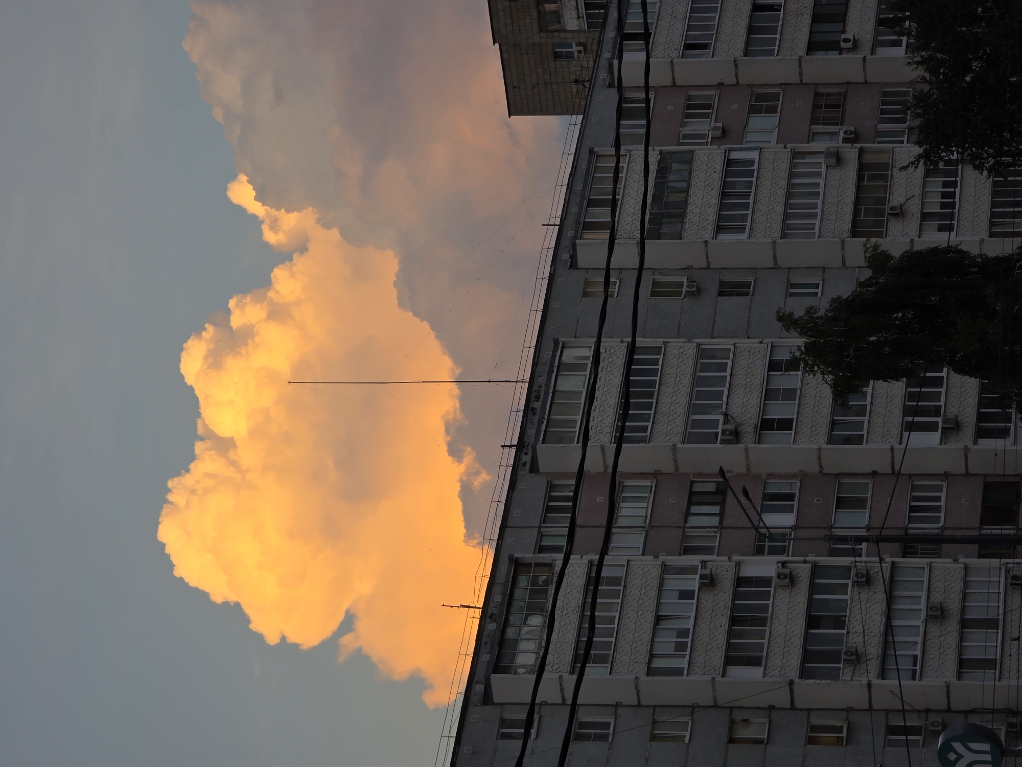 Construction site and apartment blocks at dramatic urban dusk