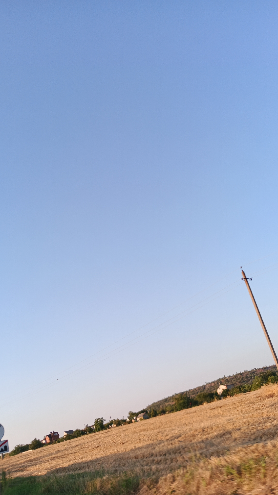 Afternoon road trip through open rural countryside at golden hour