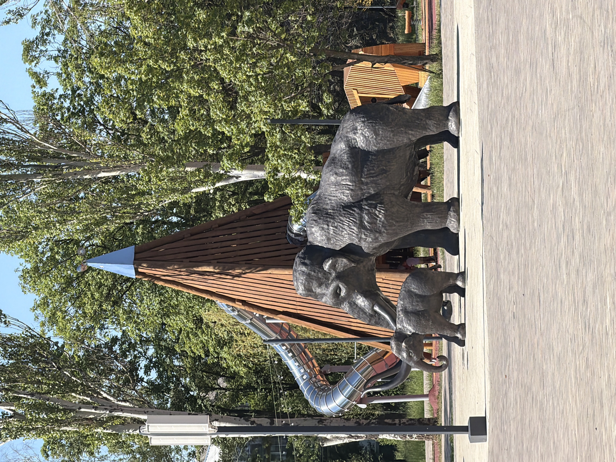 Lazy summer morning at a park with mammoth sculptures and a coffee stop