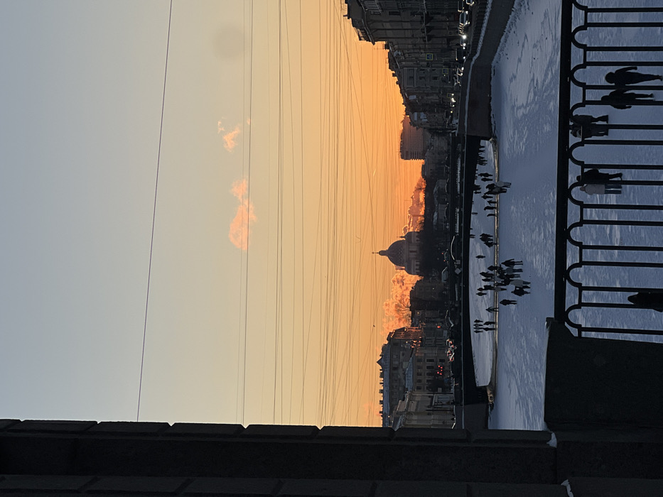 Saint Petersburg residents enjoy frozen waterways during winter sunset