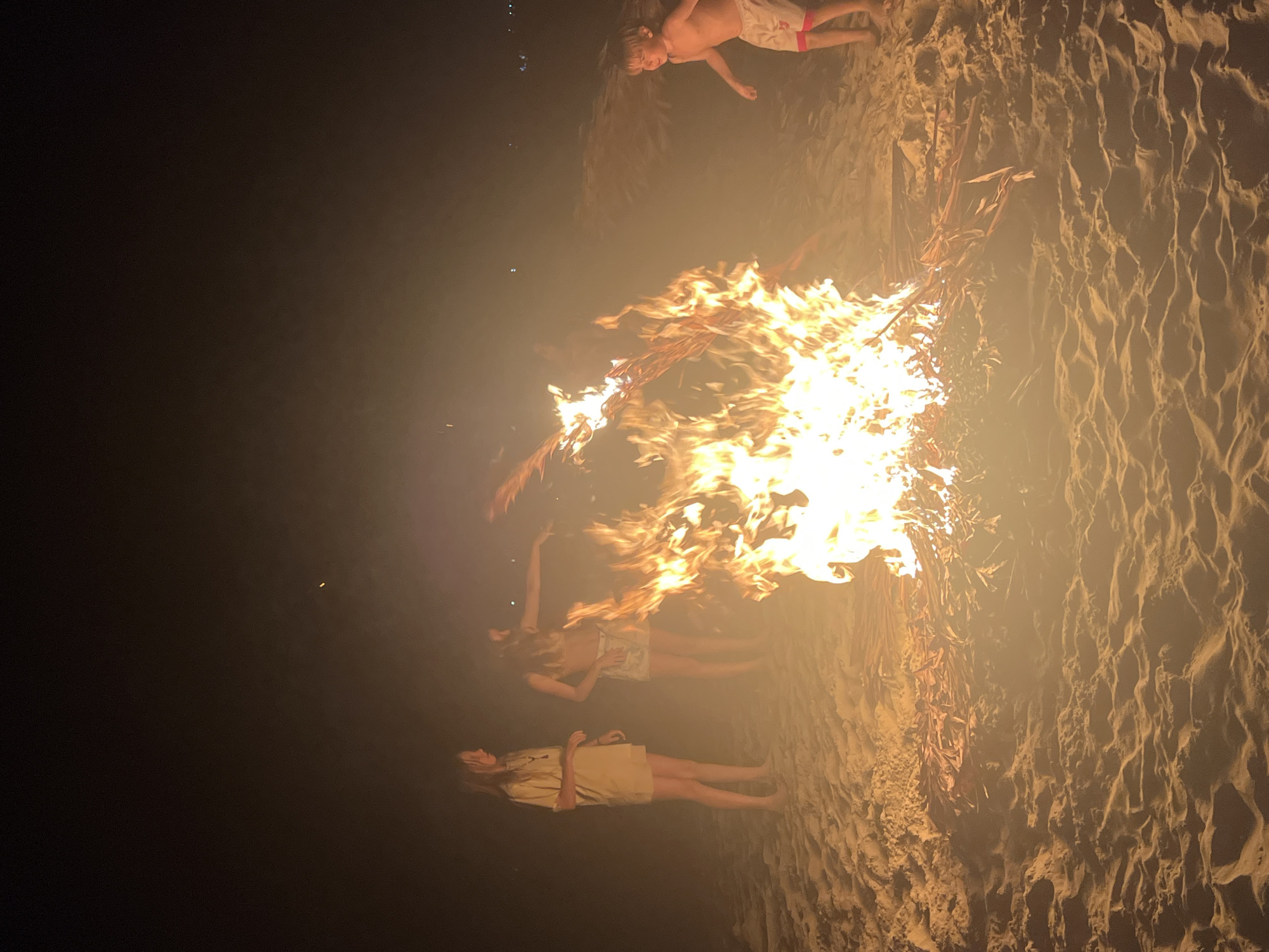 Beach bonfire gathering on the Hoi An shoreline at night