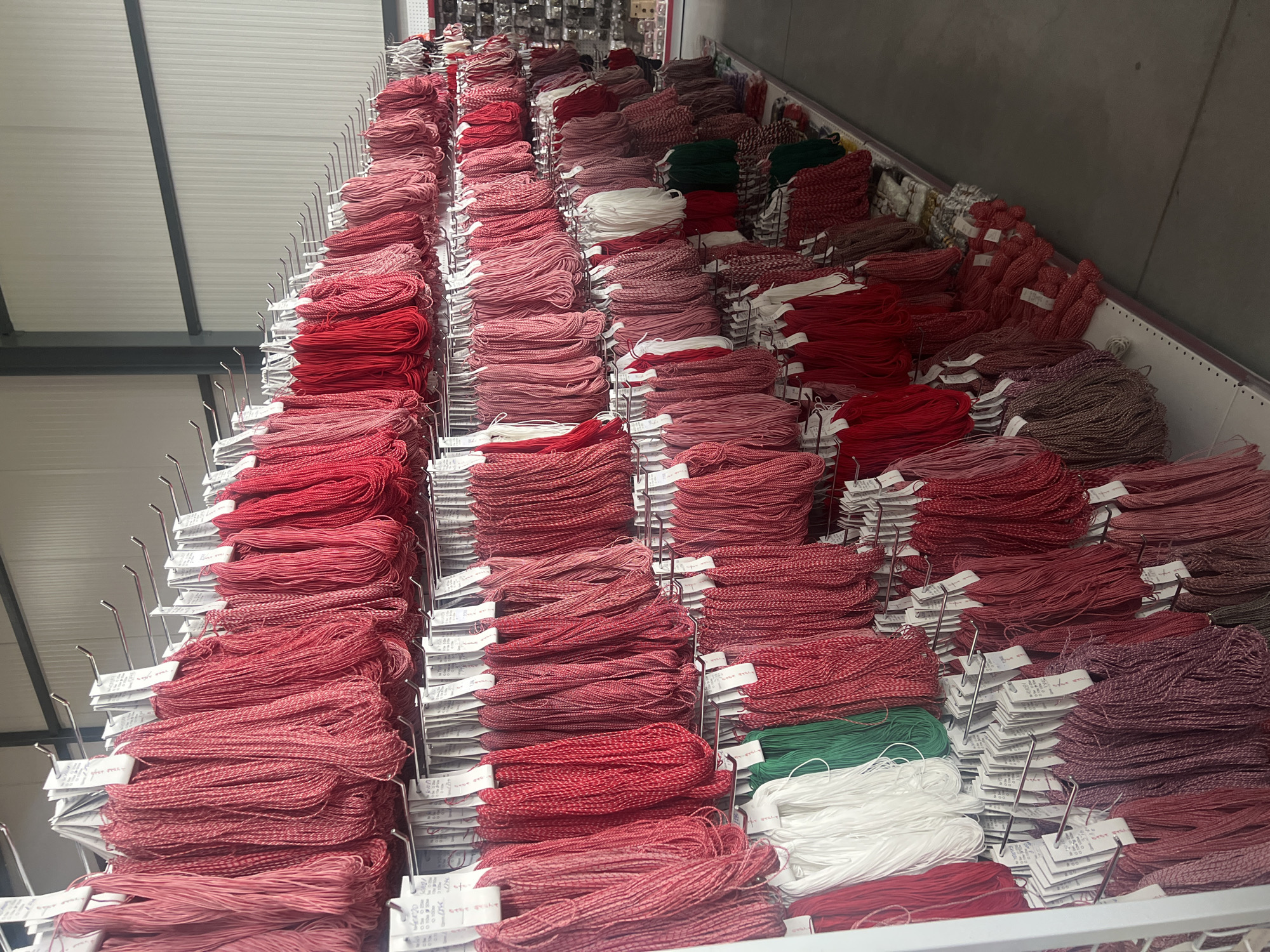 Textile warehouse stocked with red embroidery thread in Burgas