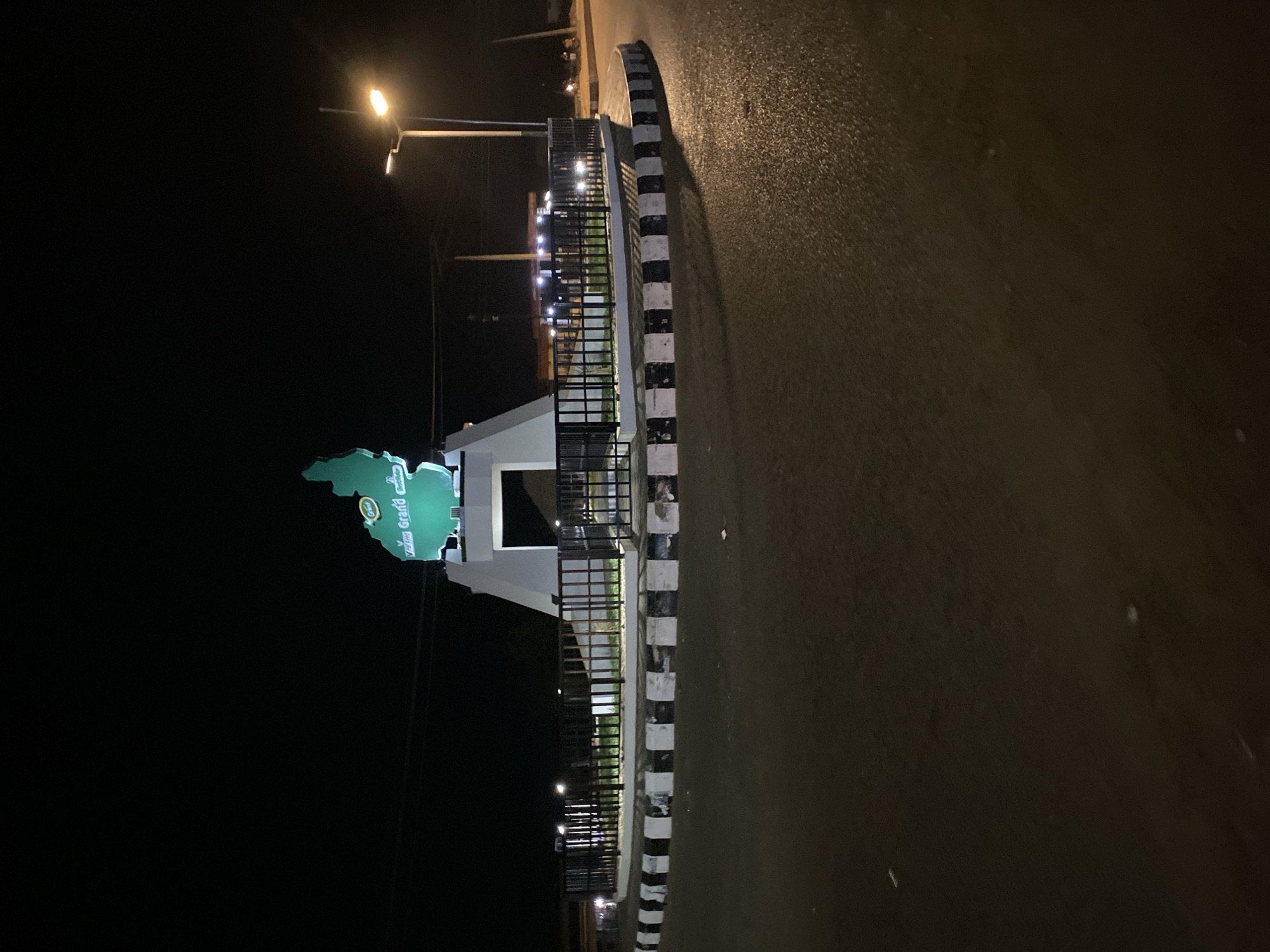 Illuminated map monument captured in nighttime Bukuru street scenes