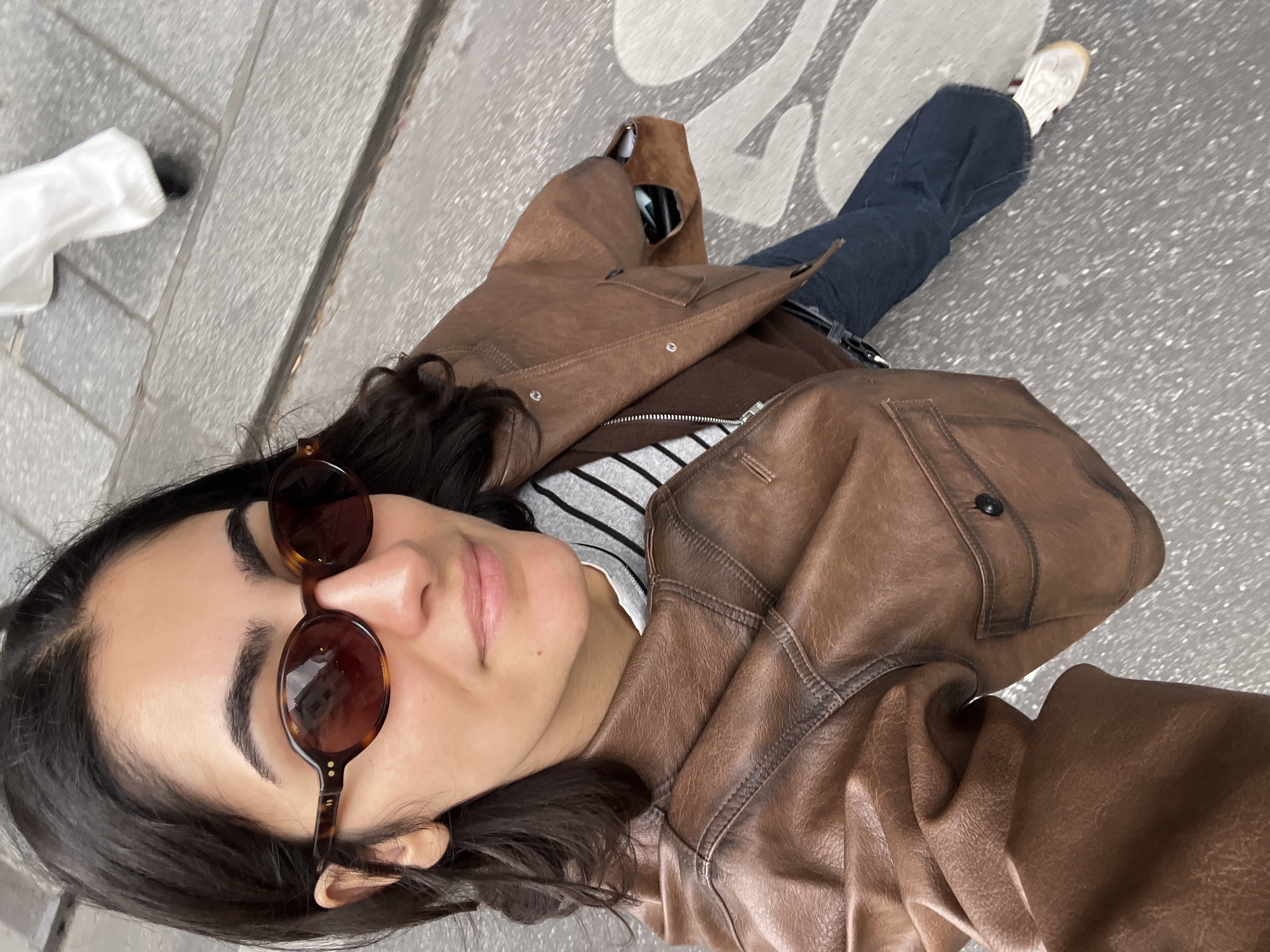 Woman takes selfies on Paris street in Montorgueil district