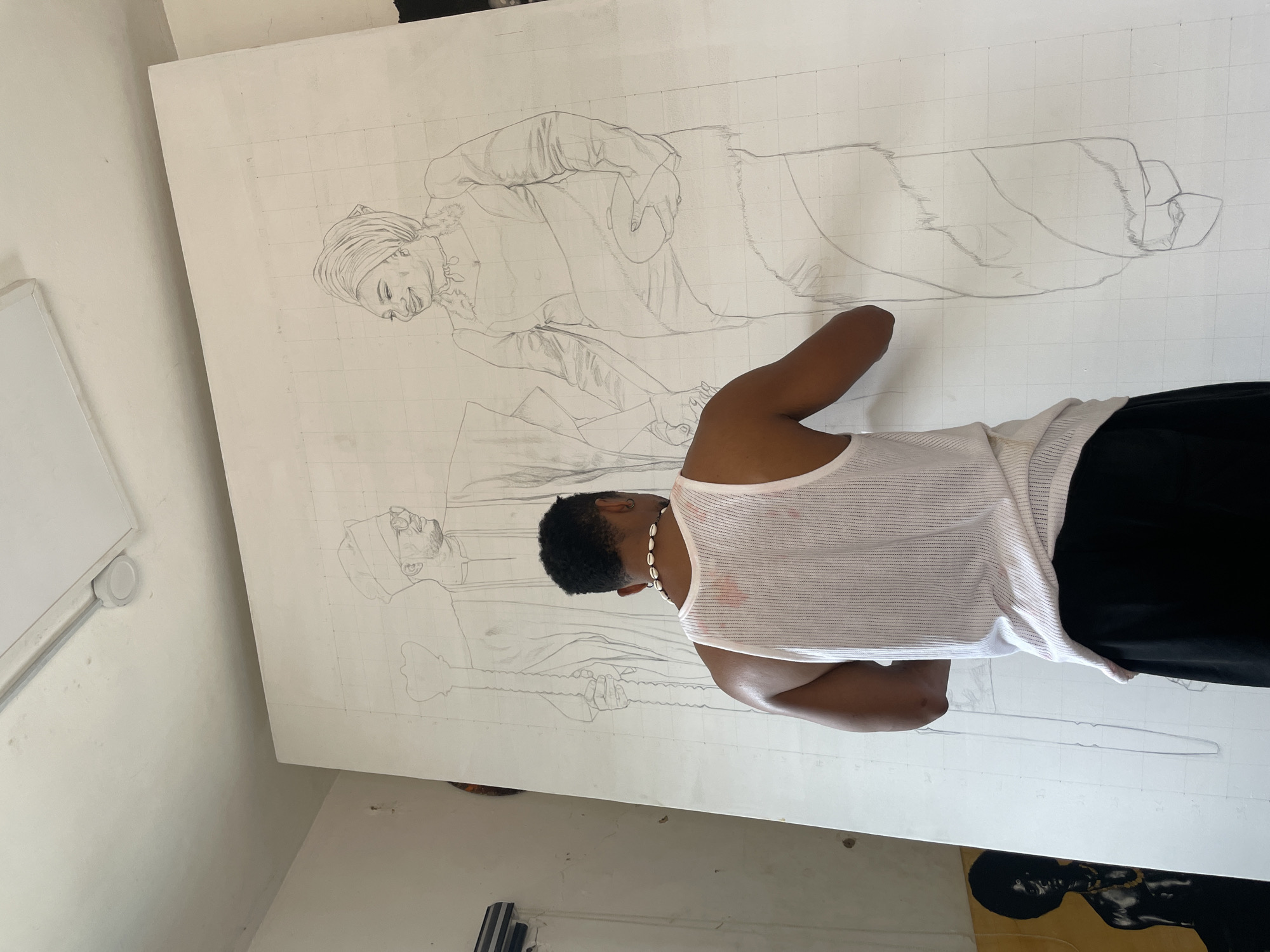 Artist creates large gridded drawing of two figures