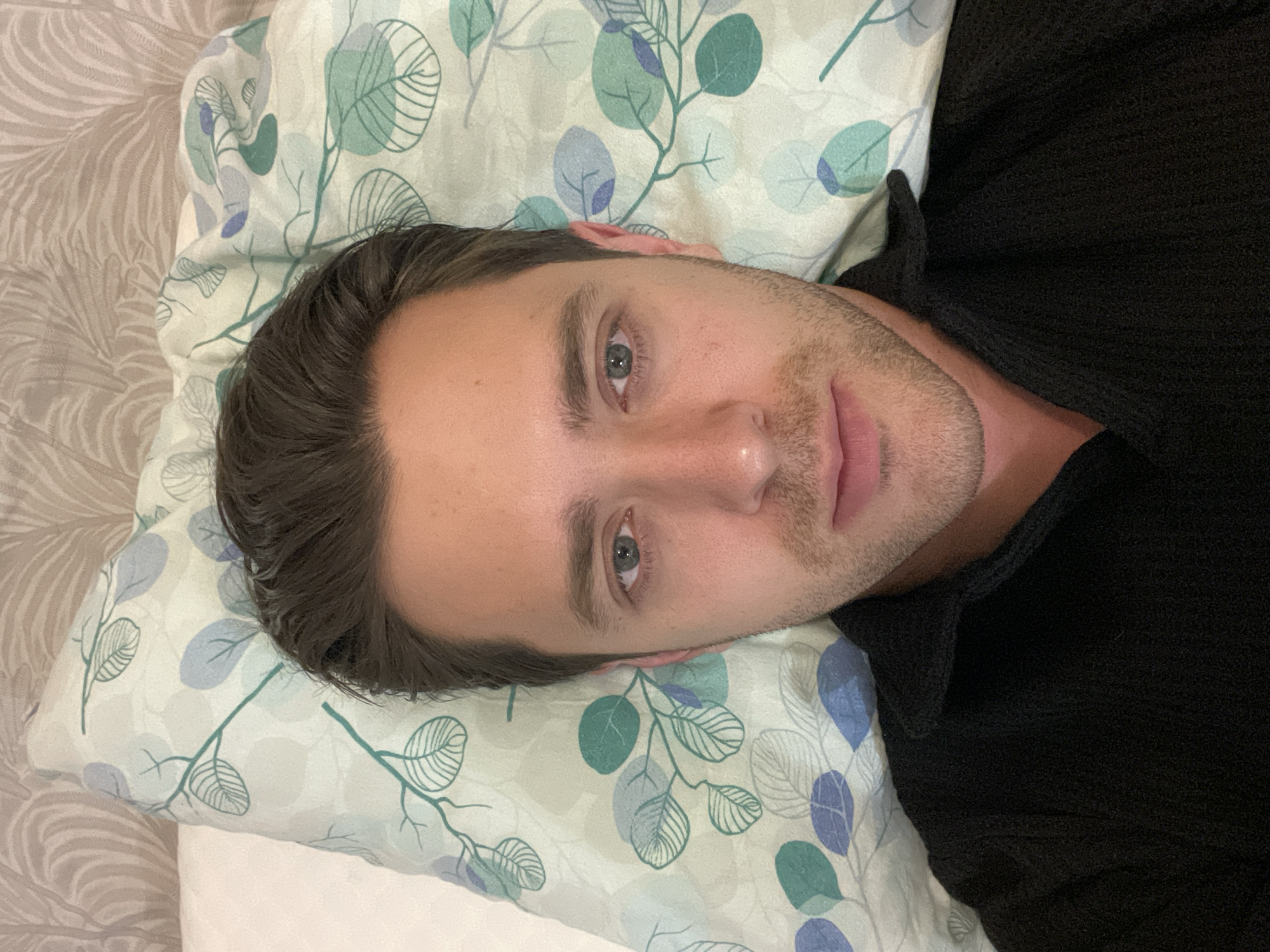 Man rests on patterned bedding in Saint Petersburg