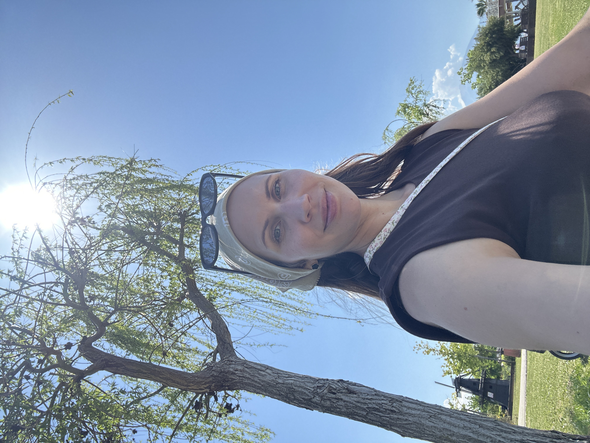 Woman photographs herself near sculpture in sunny Fethiye