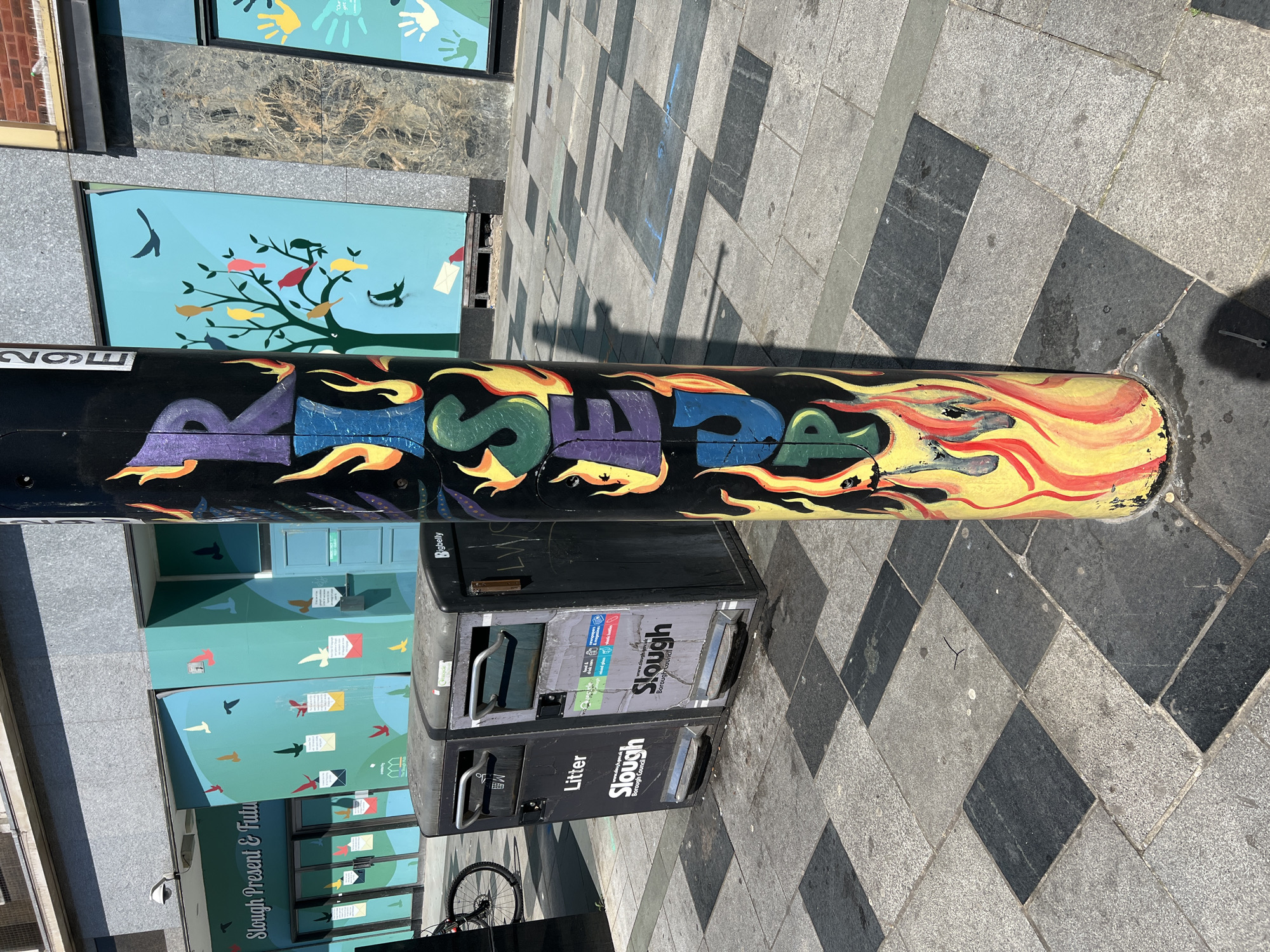 Spring street scenes documented in Slough include graffiti, blooming shrubs