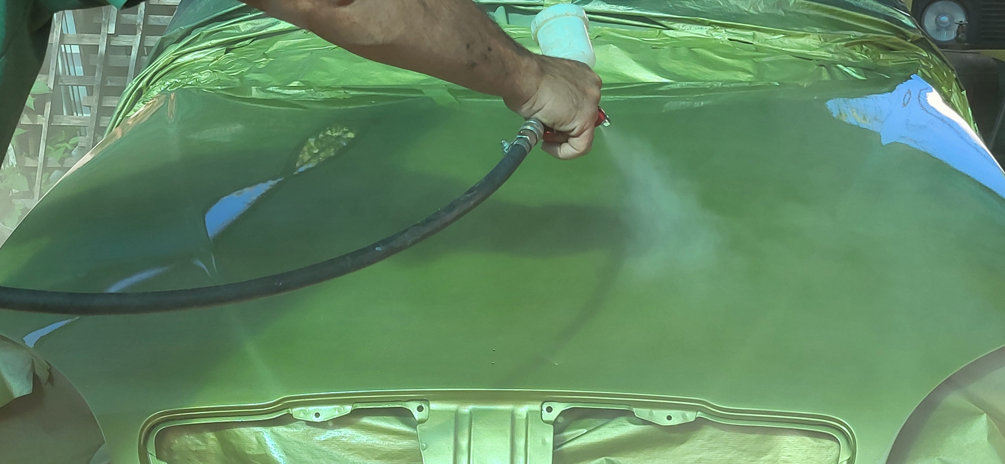 DIY metallic green respray underway on a car in Tetianivka