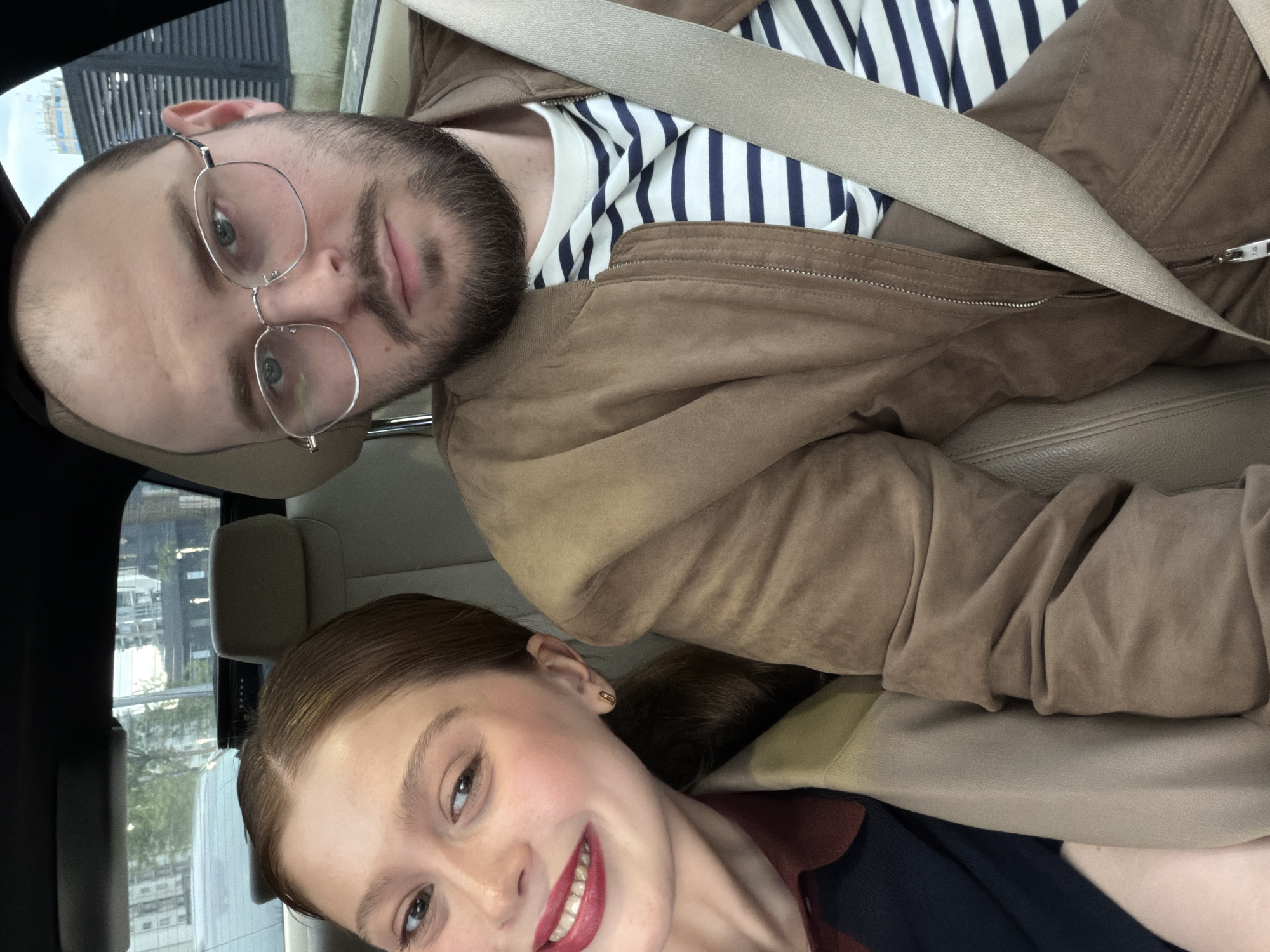 Couple photographed in car during lipstick application in Tbilisi