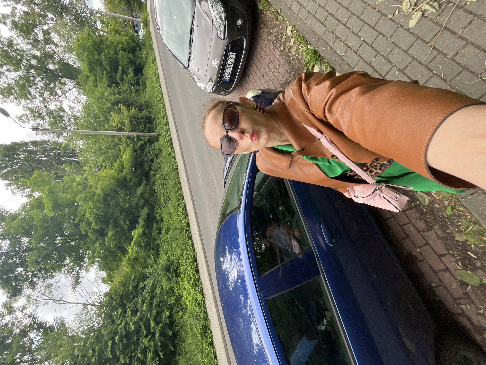 City stroll selfies near a modern church, likely Poland